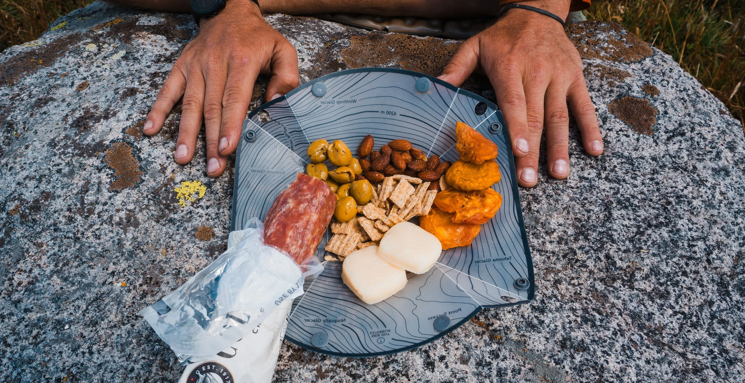 backcountry charcuterie board with fruit, cheese, nuts, olives, salami and crackers