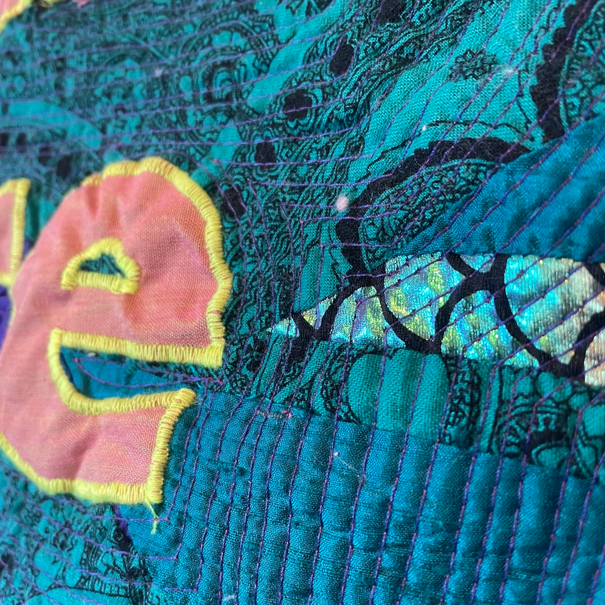 detail of Chooses words with care quilt close up on the e at the end of care