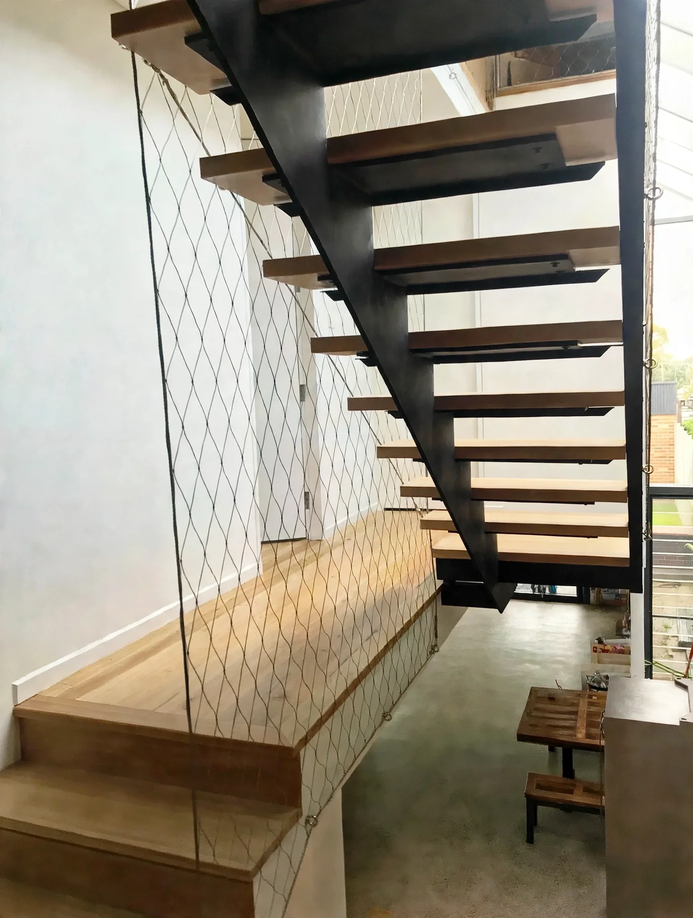Floating steel and timber staircase with woven cable balustrade net, Marrickville bungalow addition