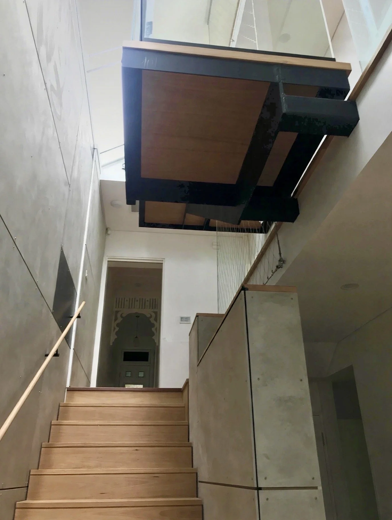 Stairwell detail showing exposed steel beam, timber treads and concrete blade wall, Marrickville renovation"