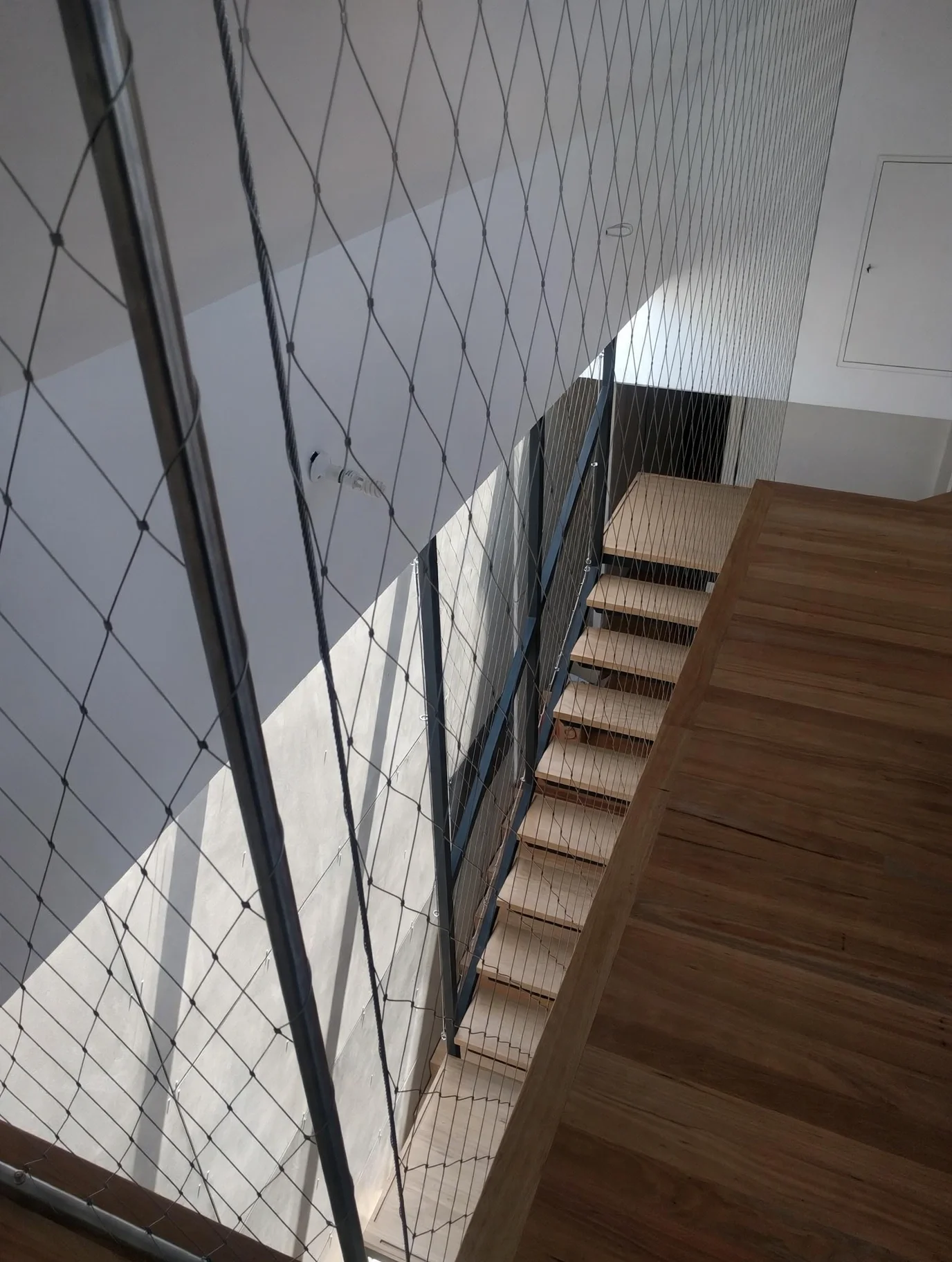 Full-height staircase with steel structure, timber treads and skylight above, Marrickville bungalow addition