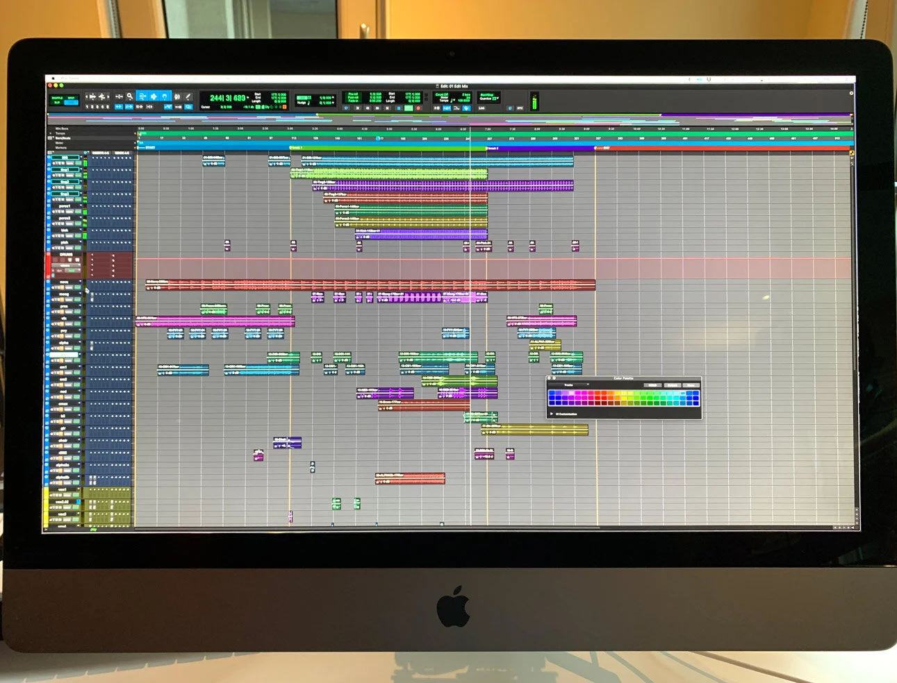 A computer display showing a digital audio workstation screen with various colored tracks and audio waveforms. Avid Pro Tools. Hashmoder (Omar Hash) (Omar Hashim)