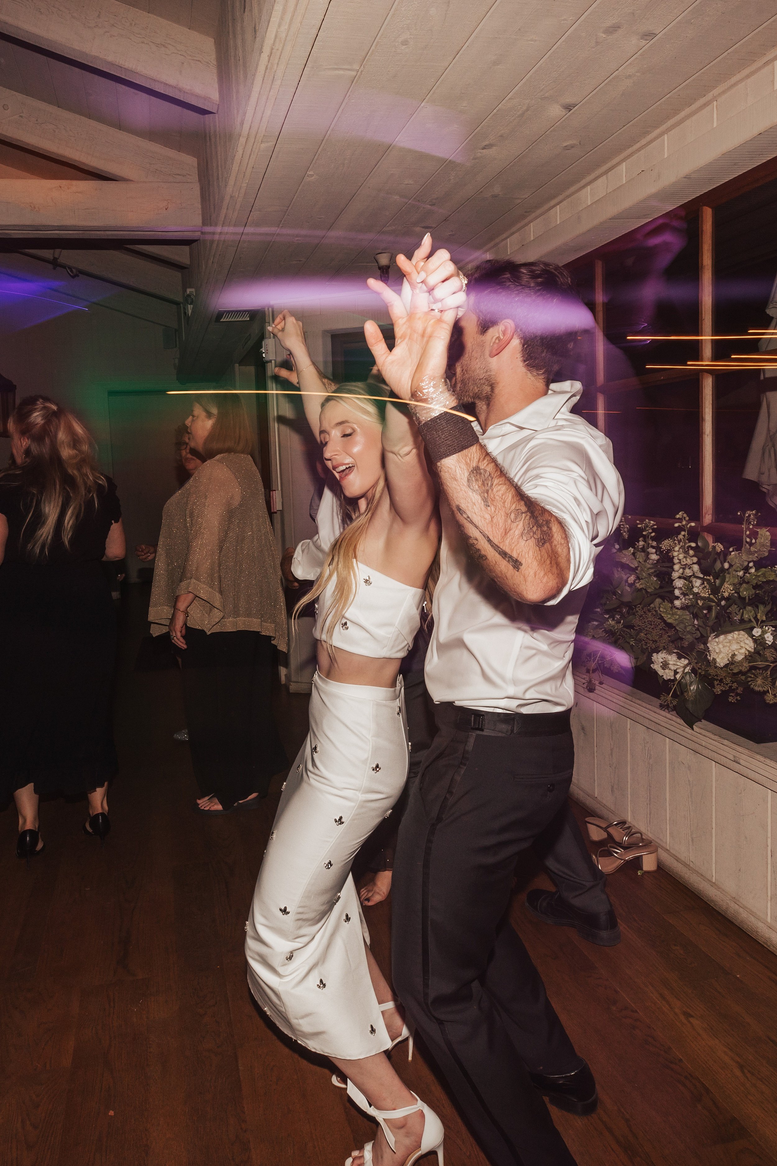 wedding couple dancing on their reception part with flash photography