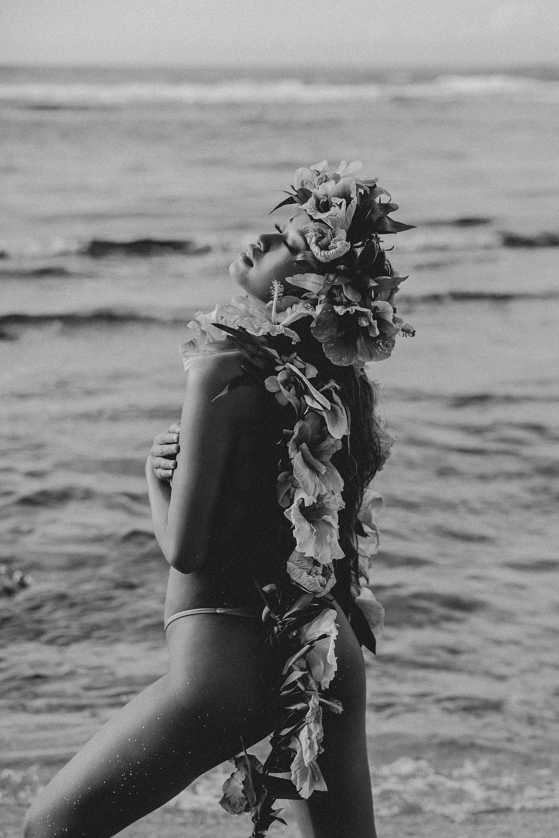     Fine art portrait session featuring handcrafted tropical florals by the ocean in Oahu Hawaii