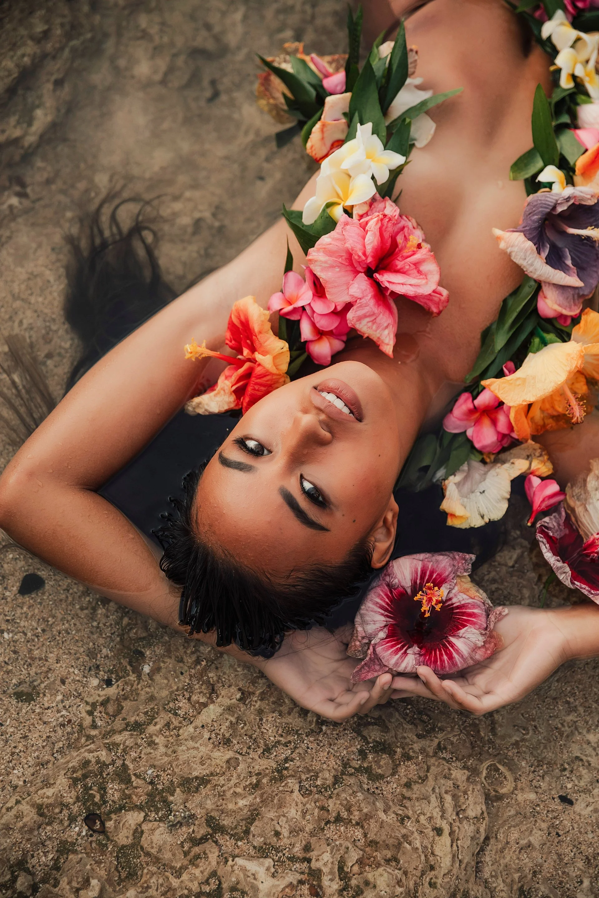     Editorial beach portrait with tropical florals and cinematic island tones