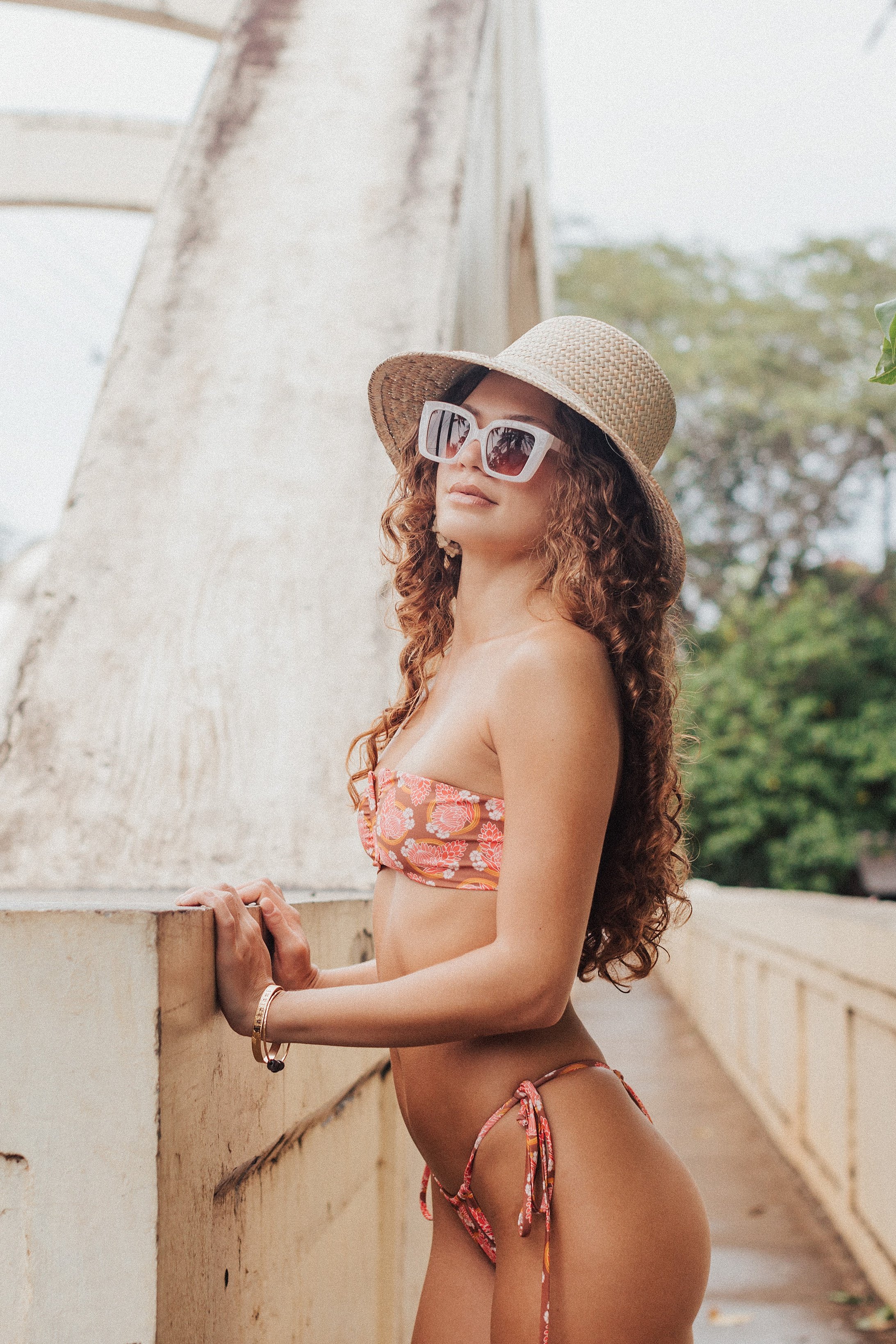 model posing beautifully for a brand by the rainbow bridge in the north shore of Oahu