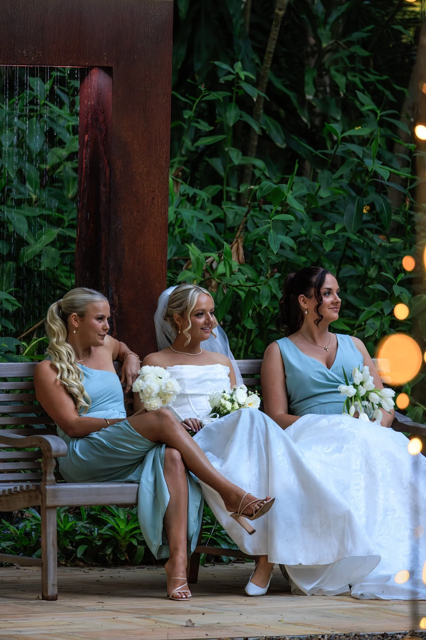 bridal-party-seated-in-in-front-of-water-arbor-in-the-grove.jpg