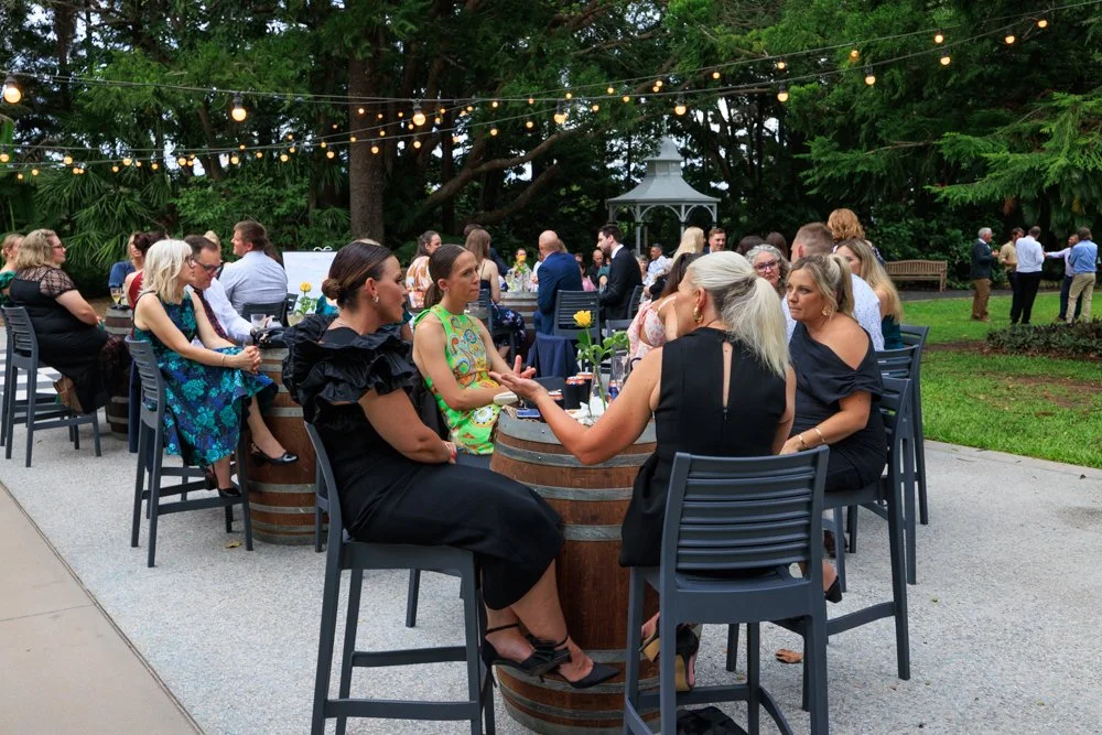 in-the-grove-garden-wedding-cocktail-guests-wine-barrels.jpg