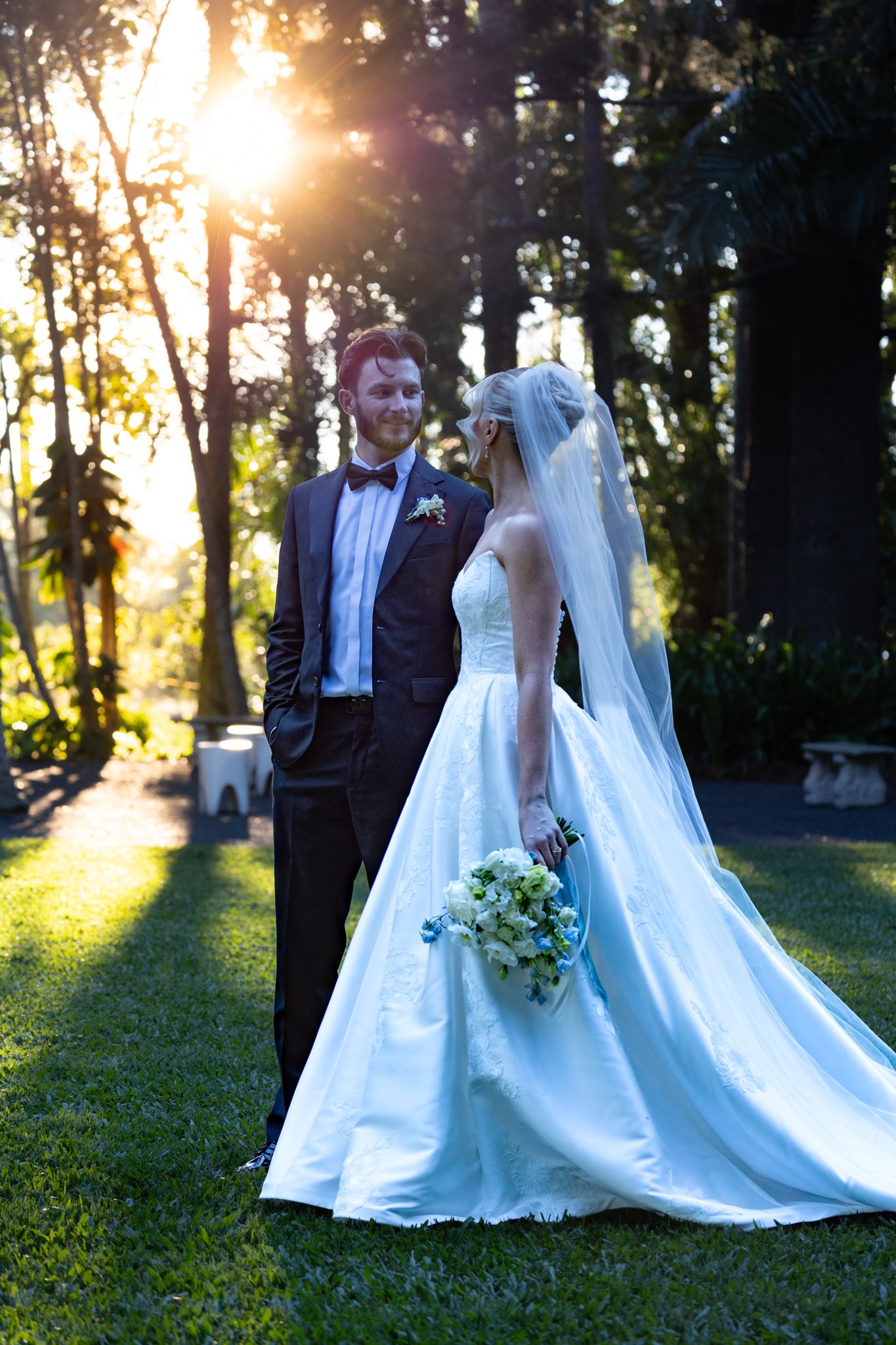 Golden hour wedding portrait captured in the gardens of In The Grove, highlighting the venue's lush surroundings and romantic sunset photography opportunities.