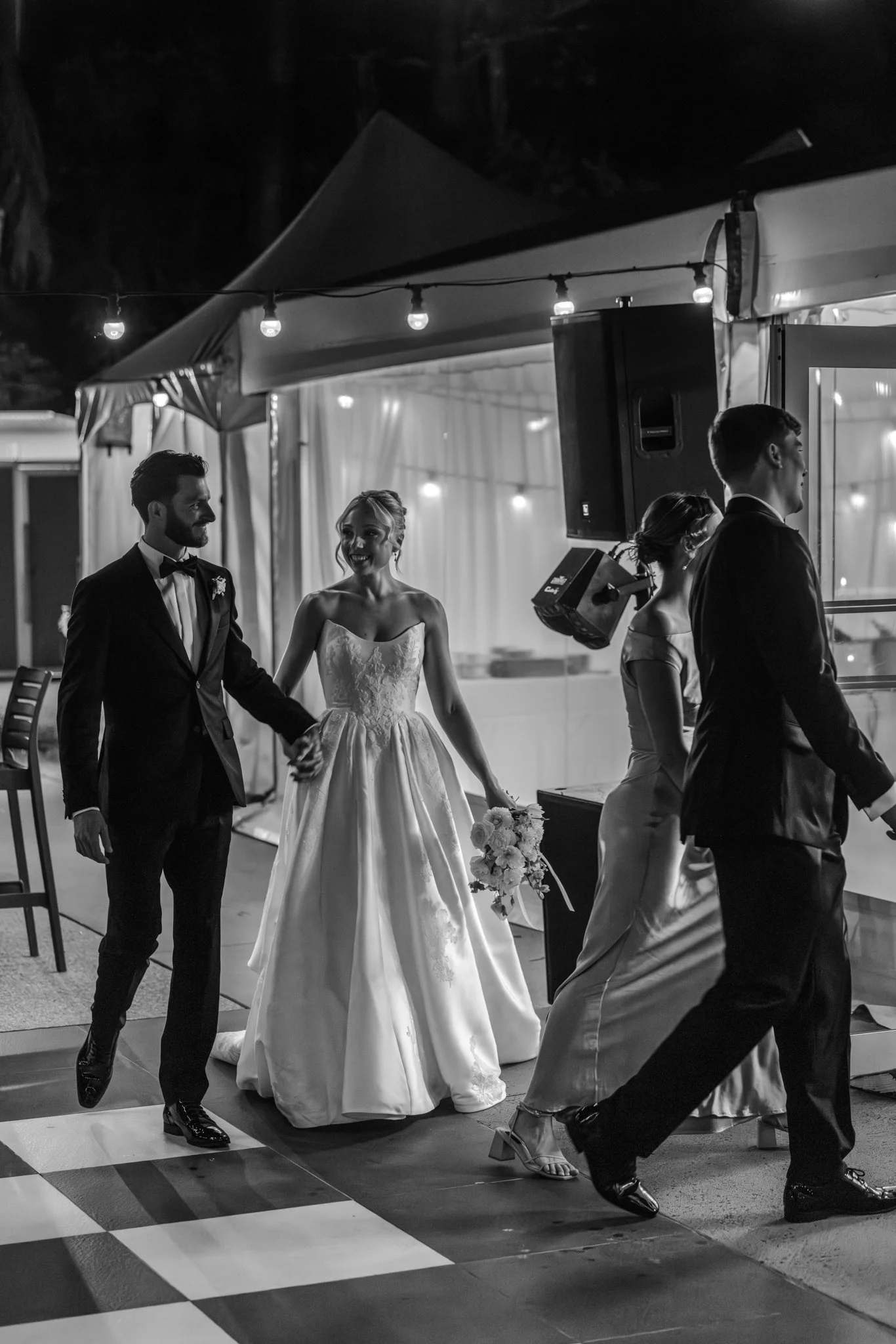 The moment the celebrations truly begin. Sarah and Ben make their grand entrance into the marquee, greeted by cheers, laughter and the excitement of the evening ahead.