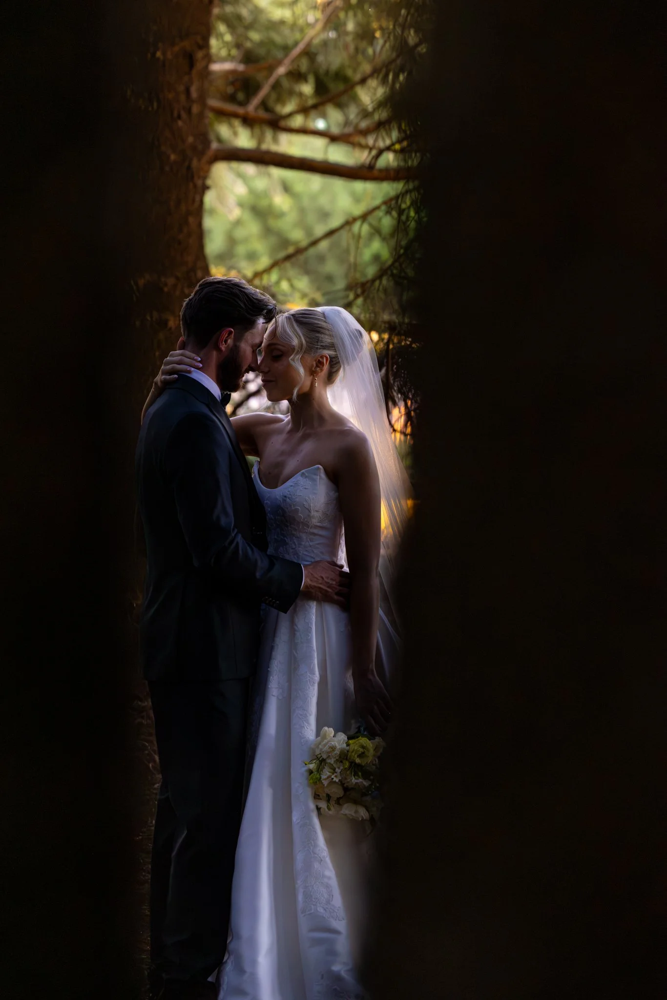 Artistic wedding photography captured amongst the mature trees and natural beauty of In The Grove, creating a timeless and romantic atmosphere.