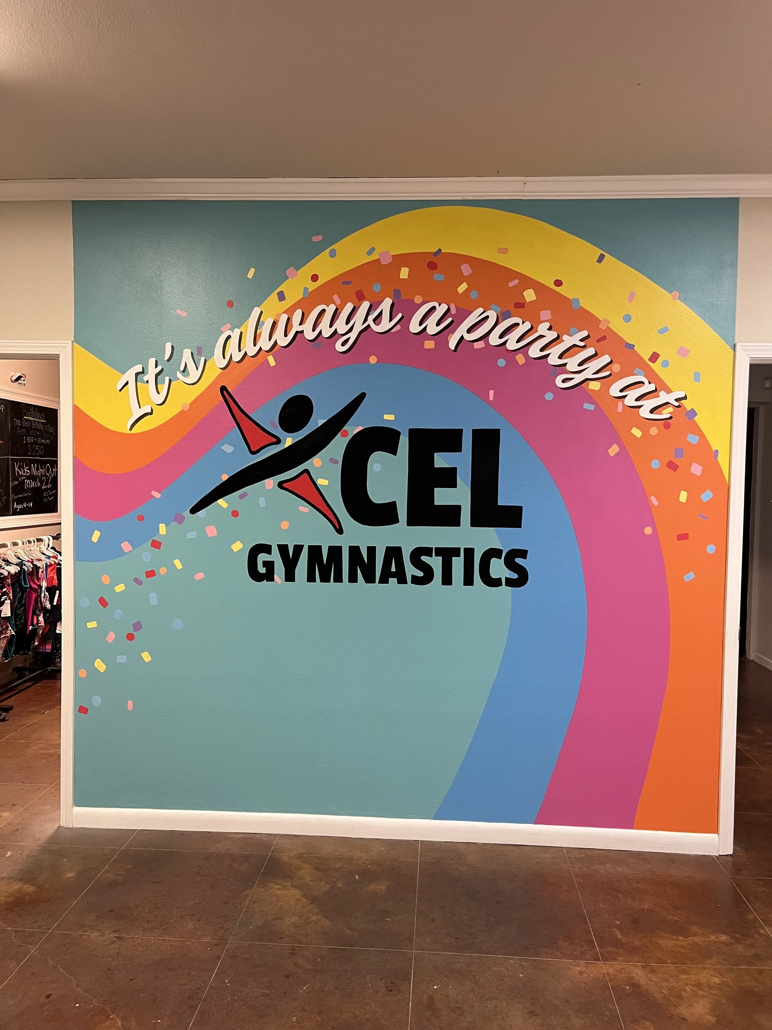 Xcel Gymnastics mural incorporating logo