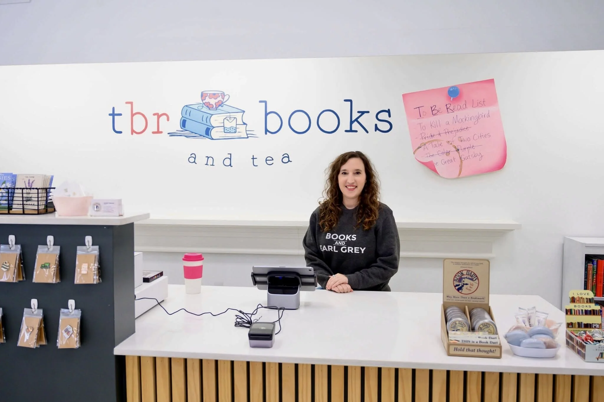 TBR Books and Tea logo with post-it note mural depicting the meaning behind “TBR”