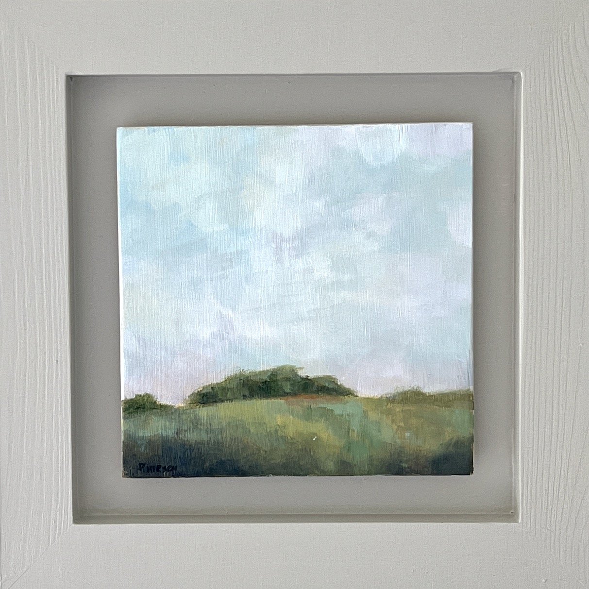 framed painting of a copse of trees on a hill