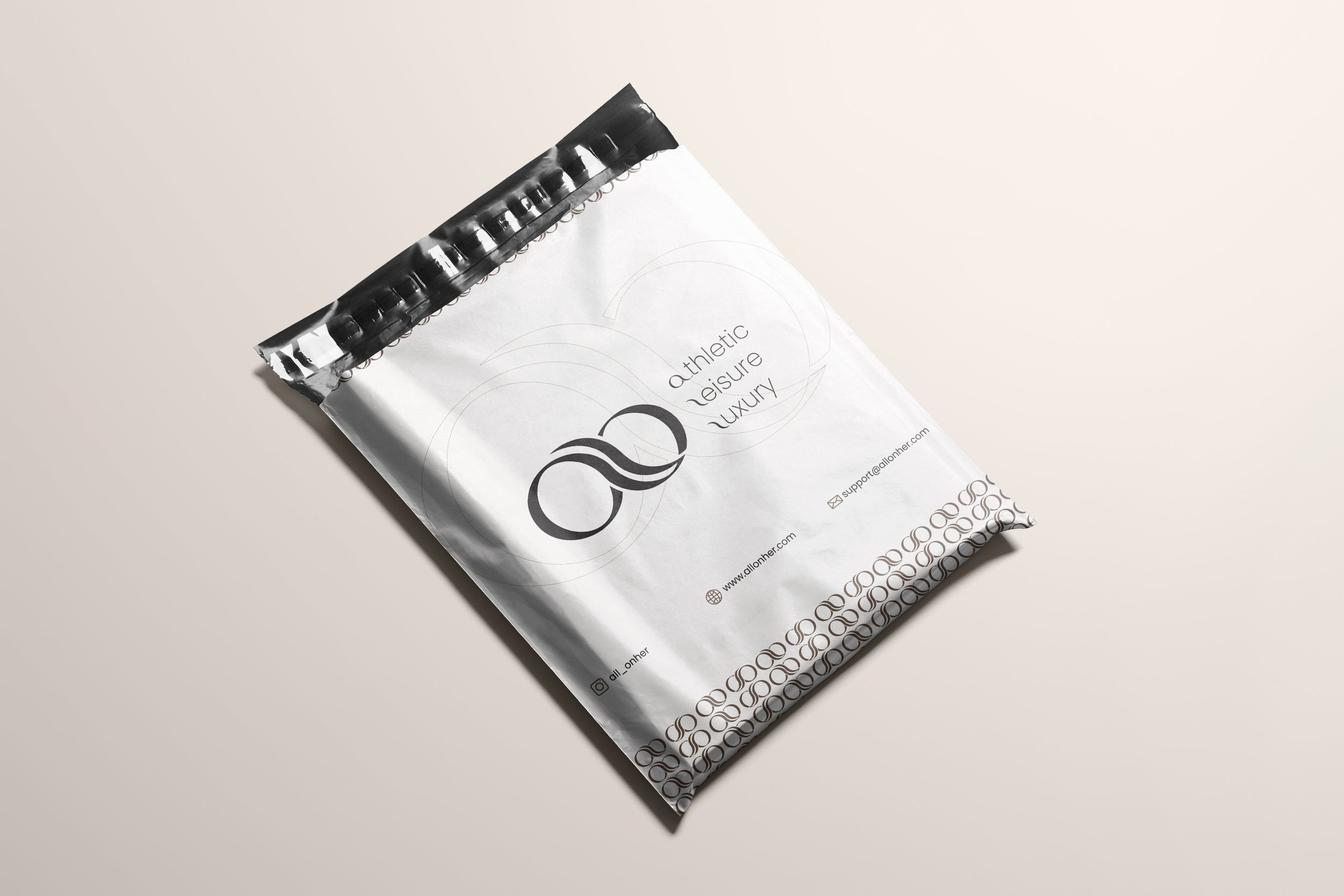 Silver plastic packaging with the logo and the words "athletic leisure luxury" printed on it.