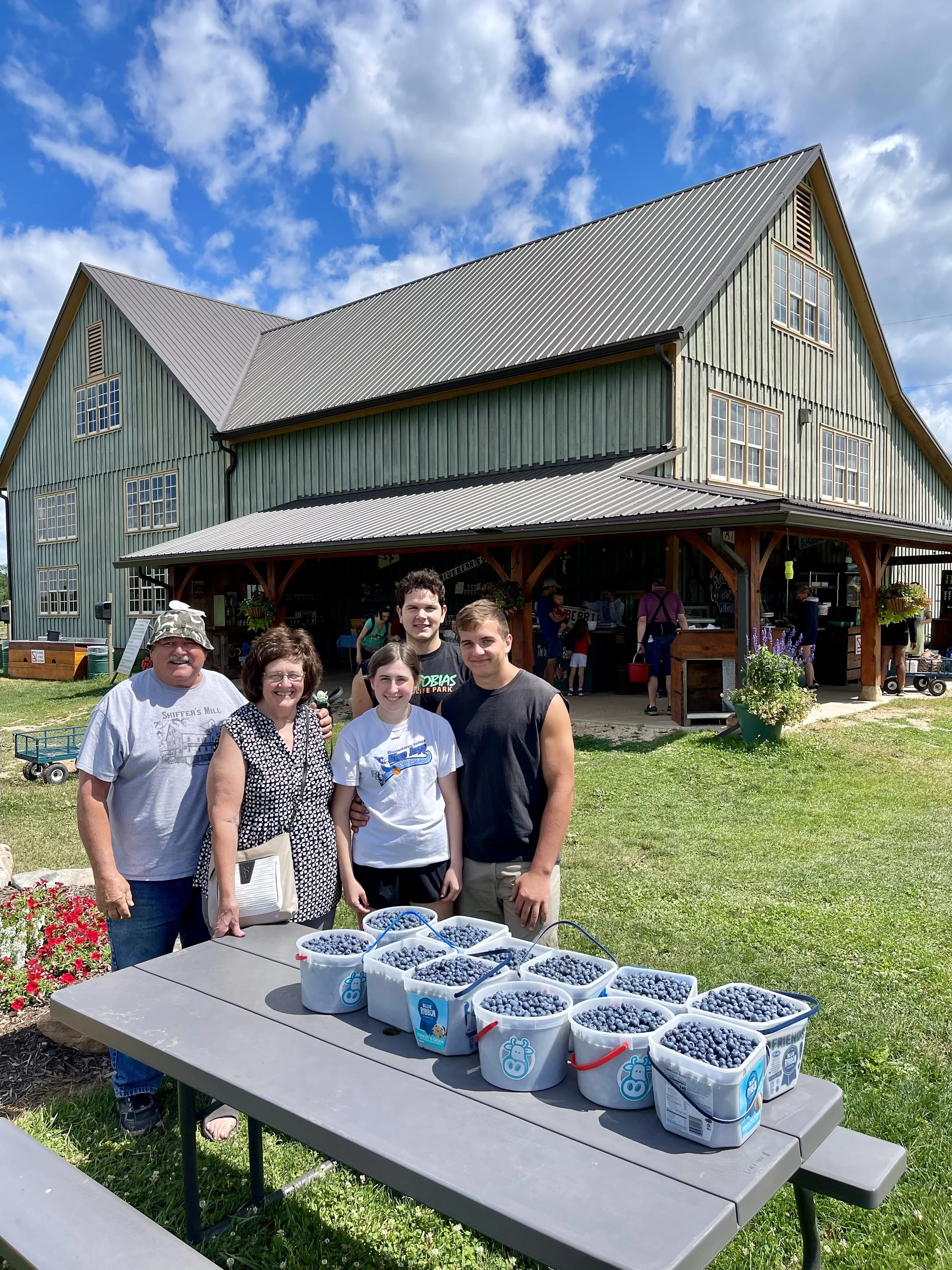 Many hands make quick work while gathering blueberries!  What a haul.