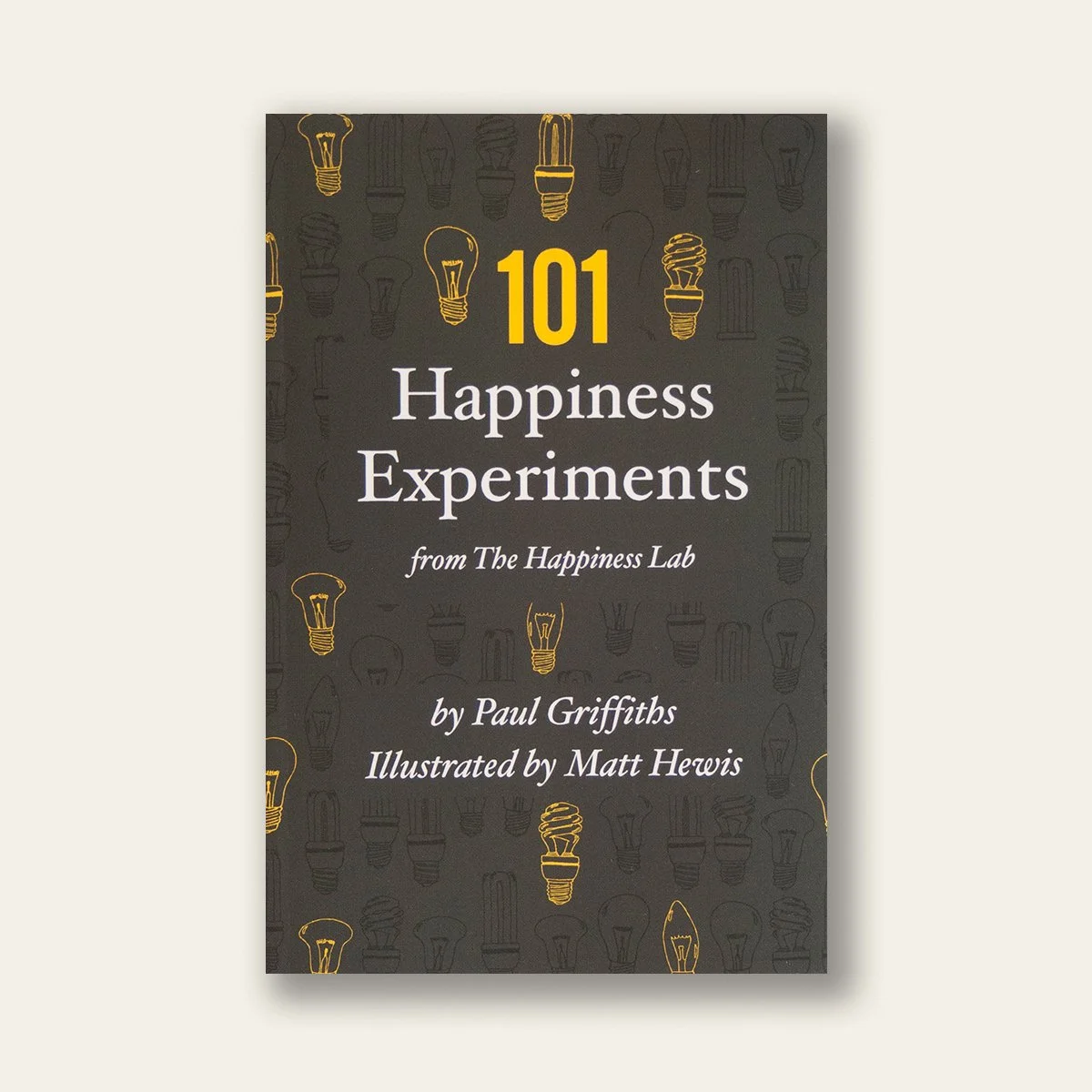 Book cover of '101 Happiness Experiments' with light bulb illustrations.
