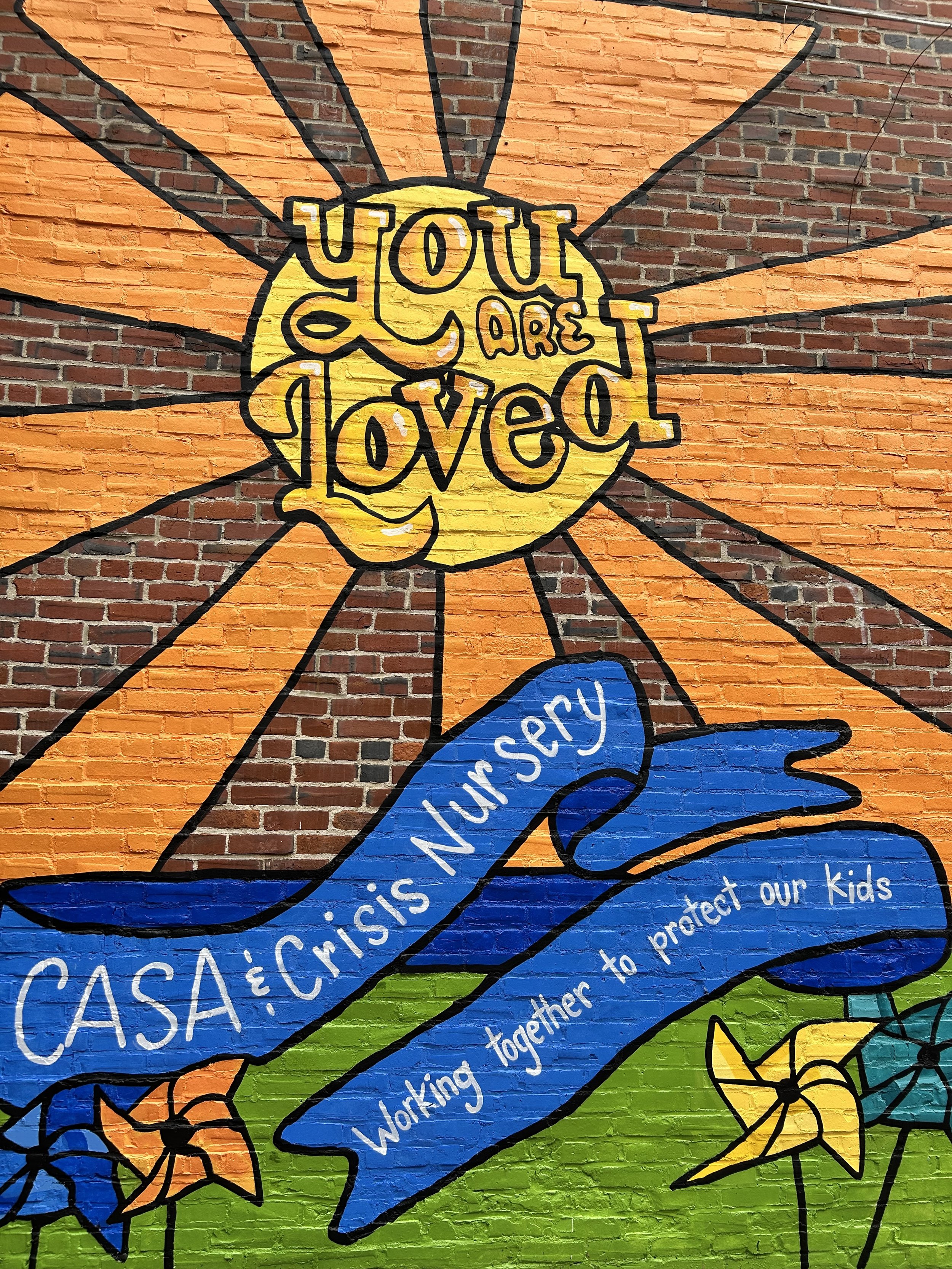 Pinwheel mural in downtown Champaign, Illinois on Experience Champaign building. Mural was funded by C.A.S.A. and Crisis Nursery of Champaign, Illinois