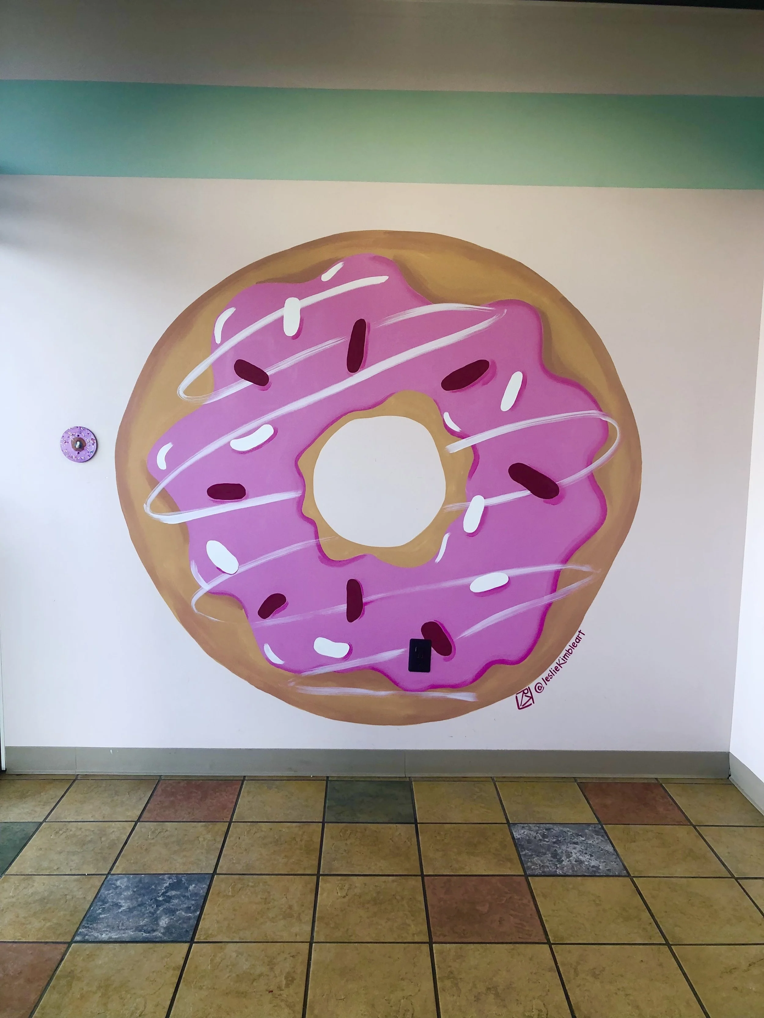 Ye Olde donut mural is one of two 6 foot donuts painted by Leslie Kimble in Champaign, Illinois
