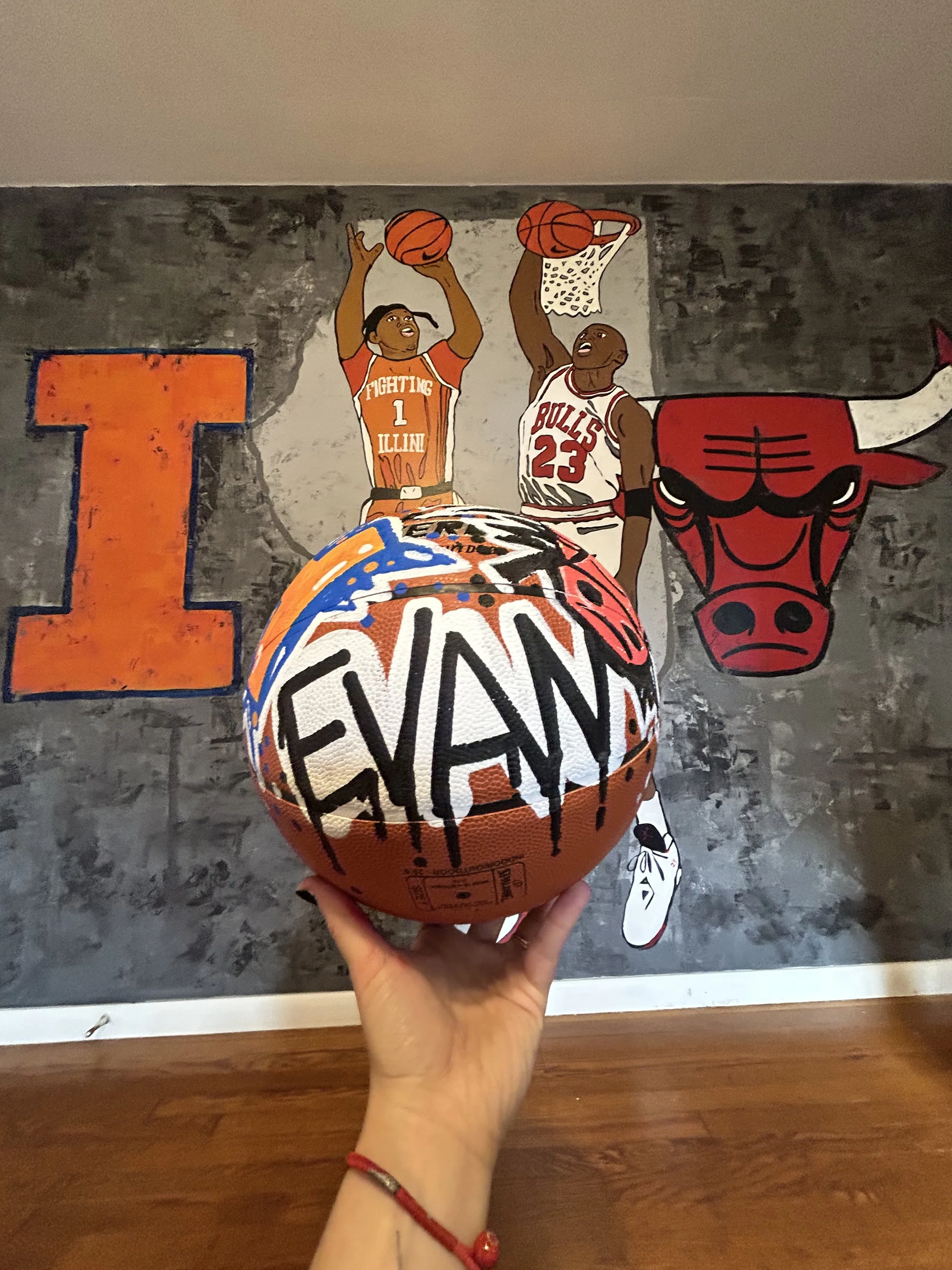 Custom hand painted basket ball to coordinate with basketball mural by Leslie Kimble