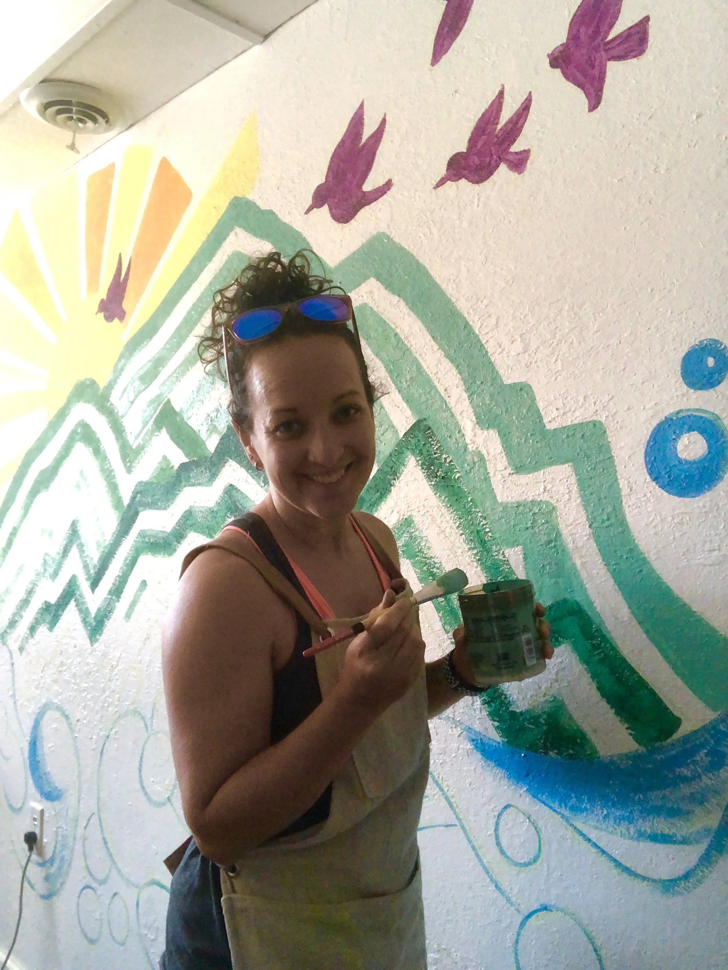 Leslie Kimble painting at  Greener Goods mural, Champaign, Illinois, 