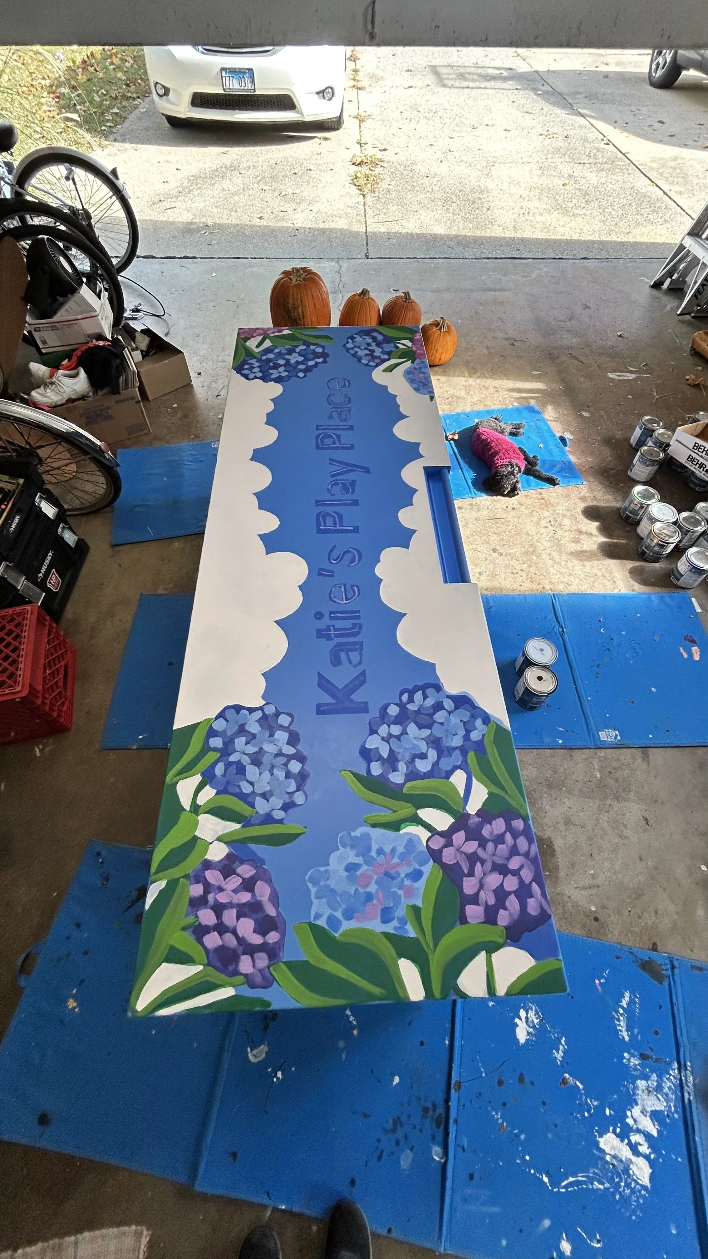 Process photo of lettering on toy box mural at Katies Play Place in Clark Park in Champaign, Illinois