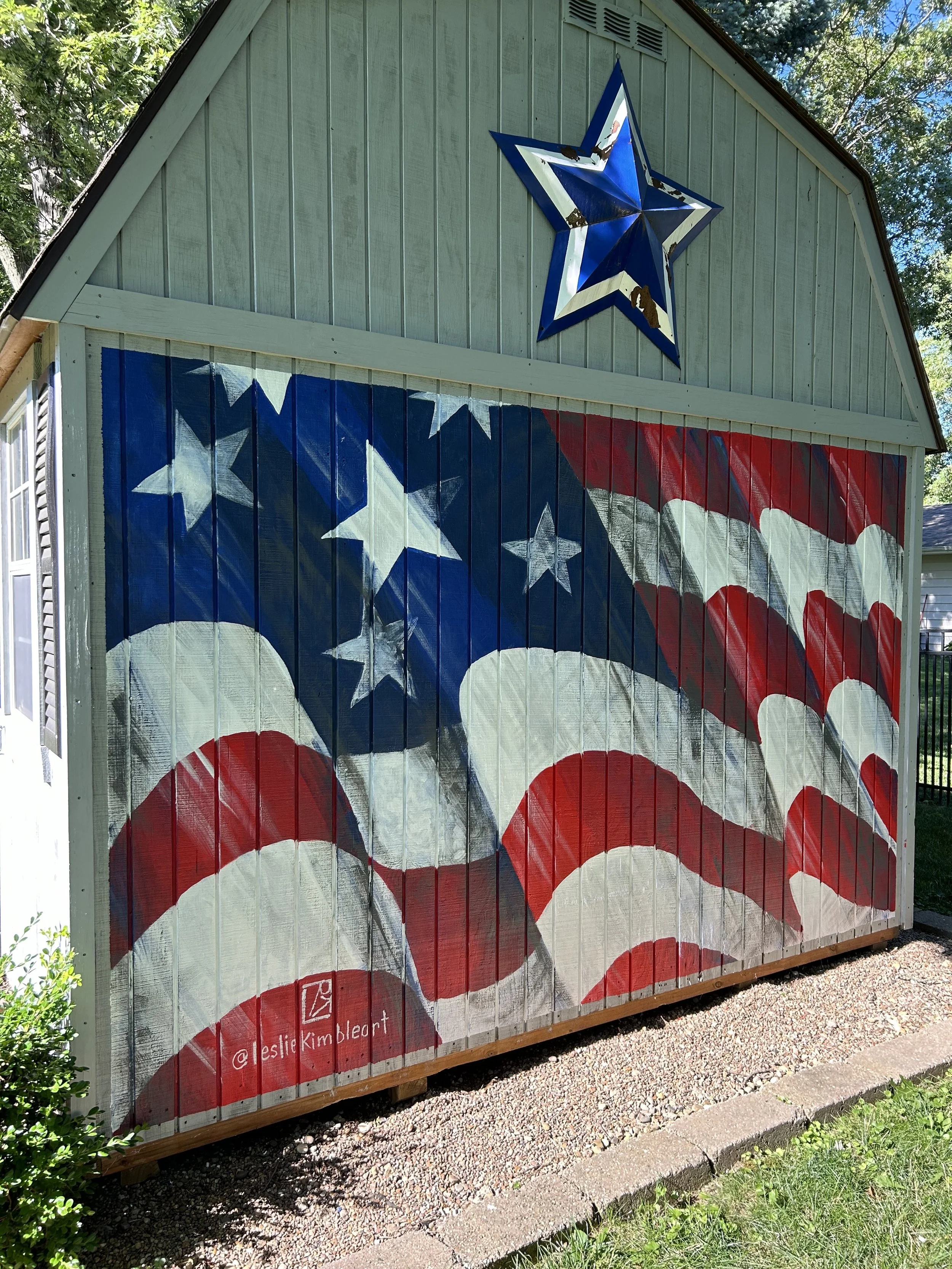 flag mural on the side of a shed in Mahomet, Illinois by Leslie Kimble Art