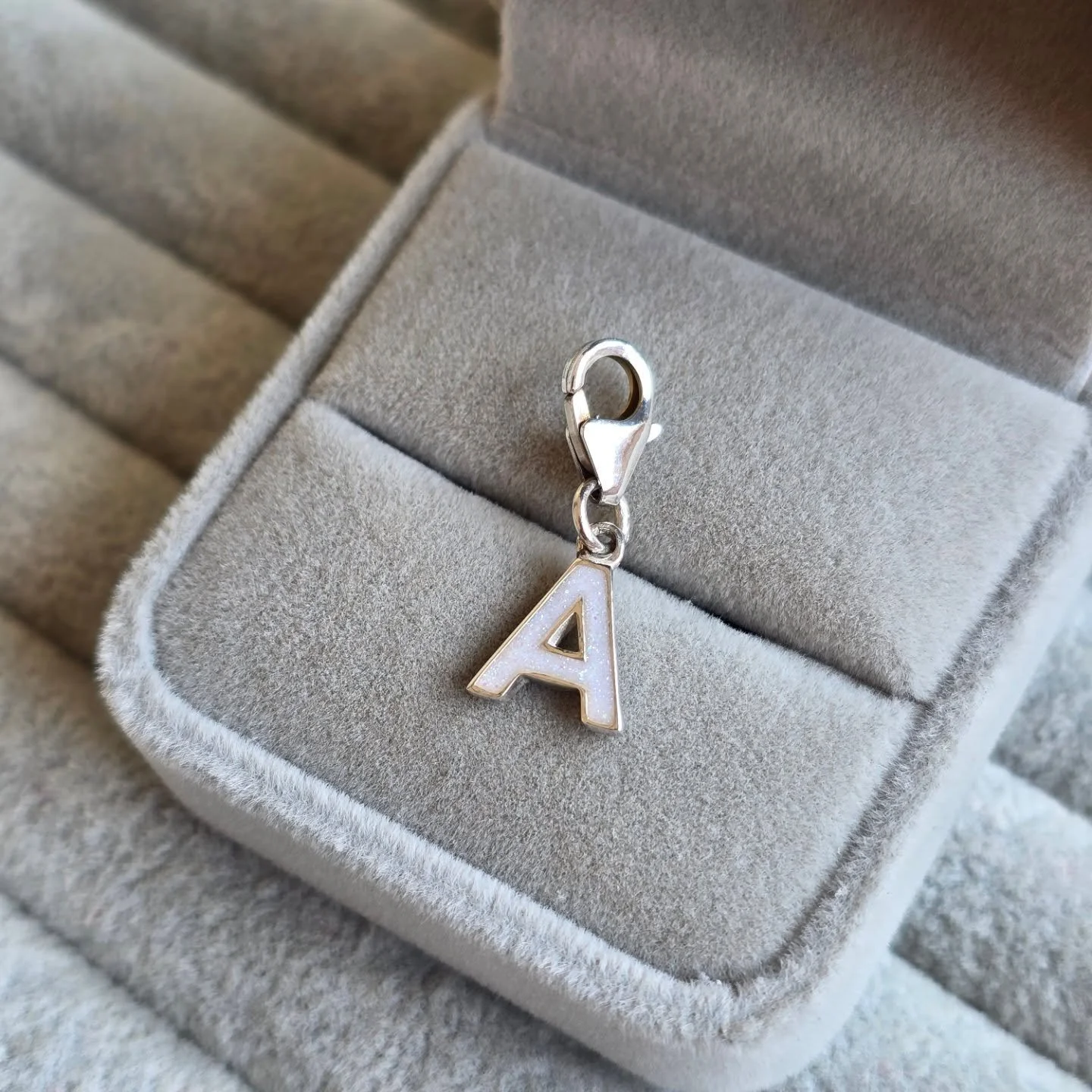 ✨ New Arrival ✨

This beautiful initial charm was first created as a custom design for one of my lovely clients to fit their Thomas Sabo charm bracelet. Inside the letter is preserved breastmilk with a subtle opal shimmer, making it a truly personal 