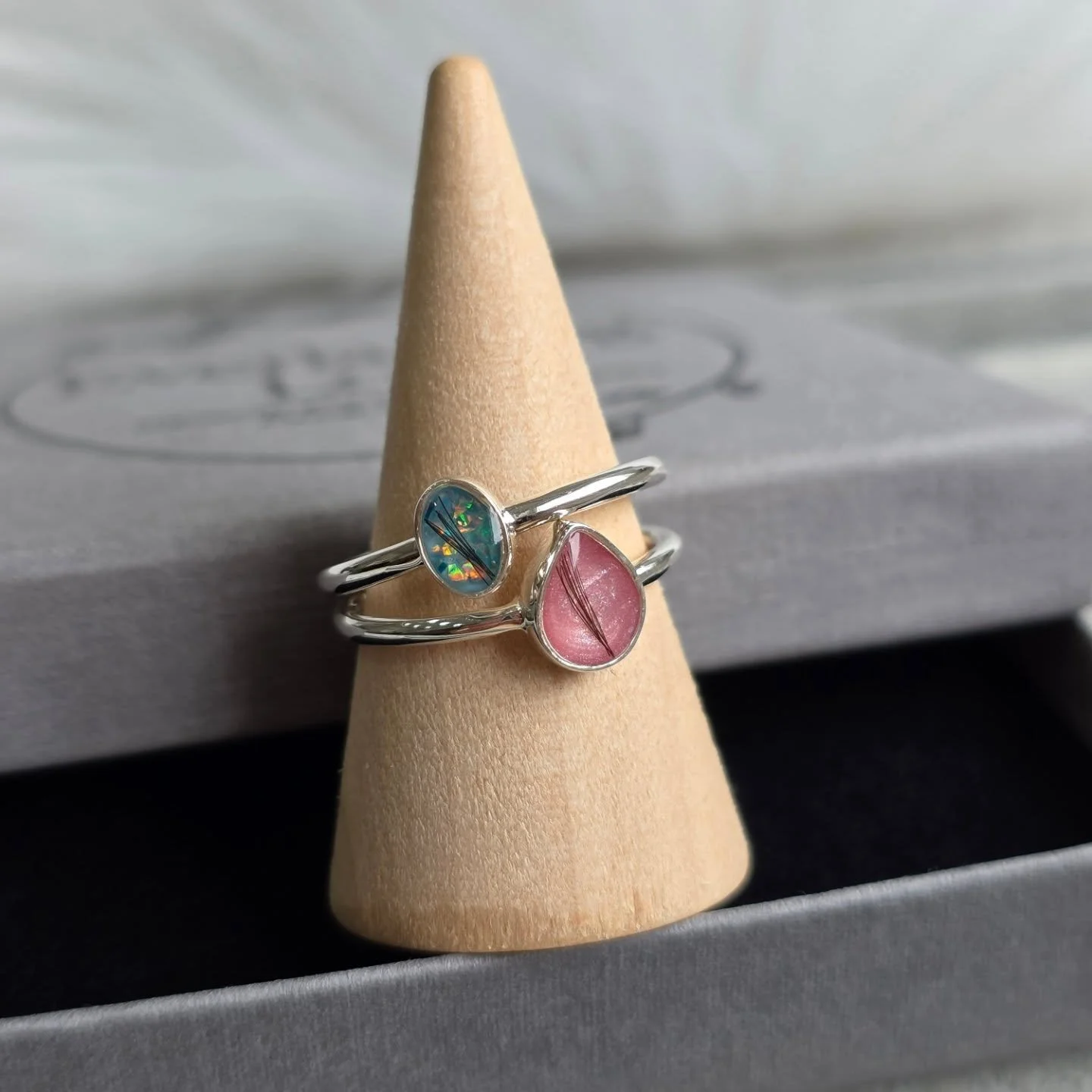 ✨ Two meaningful keepsakes, side by side.

💙 Alia Ring &ndash; Aqua crushed opal with visible hair
💗 Ivy Ring &ndash; Pink shimmer with visible hair

Beautiful reminders of everlasting love. 🤍
Each piece is handcrafted with care, turning treasured