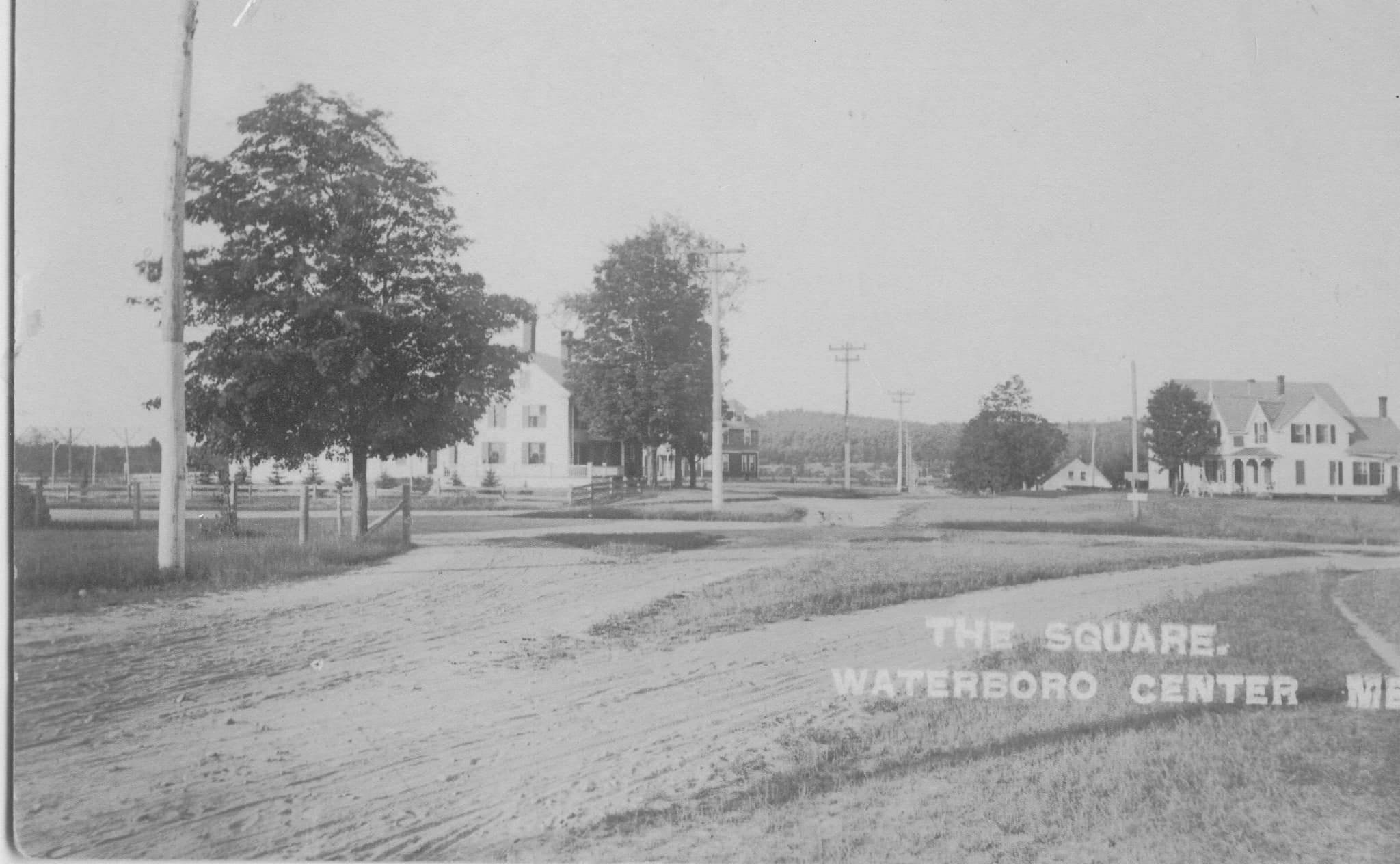 Waterboro Center before 1900-Taylor House on the left with Ossipee Hill Rd. straight ahead. The house on the right was built by Benjamin Leavitt, later owned by Tibbetts family, and burned before 1900.