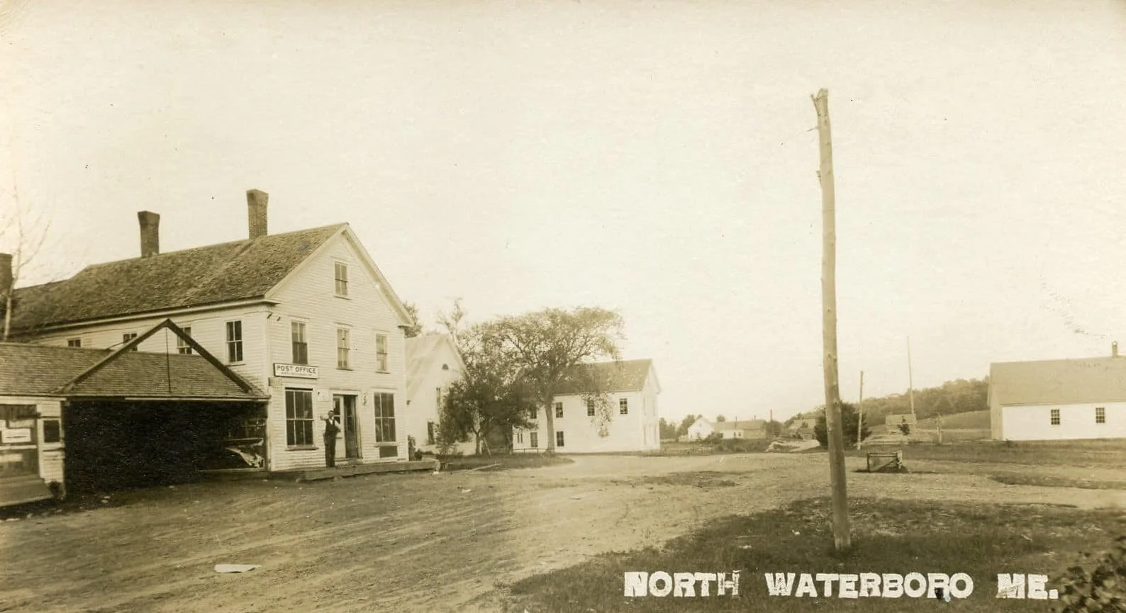 This picture was taken from the entrance of the current N. Waterboro Post Office looking south.

On the left side is the John Chase Store/Post Office (present house on that corner is now owned by the Roberge family).
Beyond that is the Knights of Pyt
