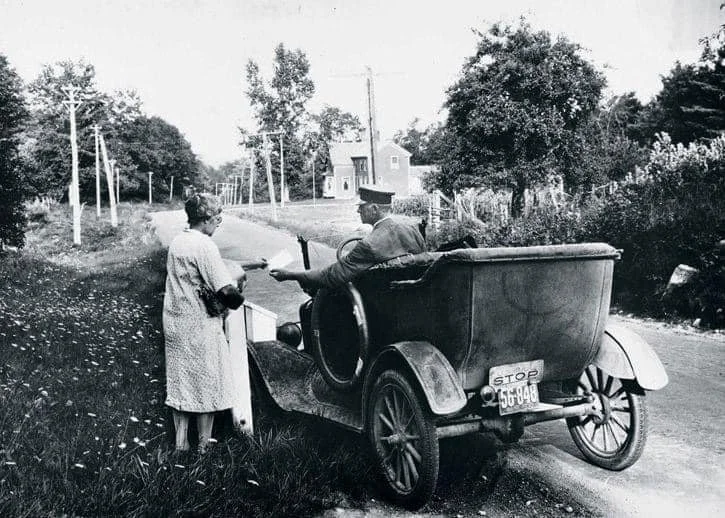 Louise Bradbury ("Aunt Lou") on the left and George E. Meserve delivering mail. He was a rural carrier in Hollis for 28 years starting in 1904 from horse and buggy. (Louise was the wife of Lewis Bradbury of Hollis.) Information from A History of Holl