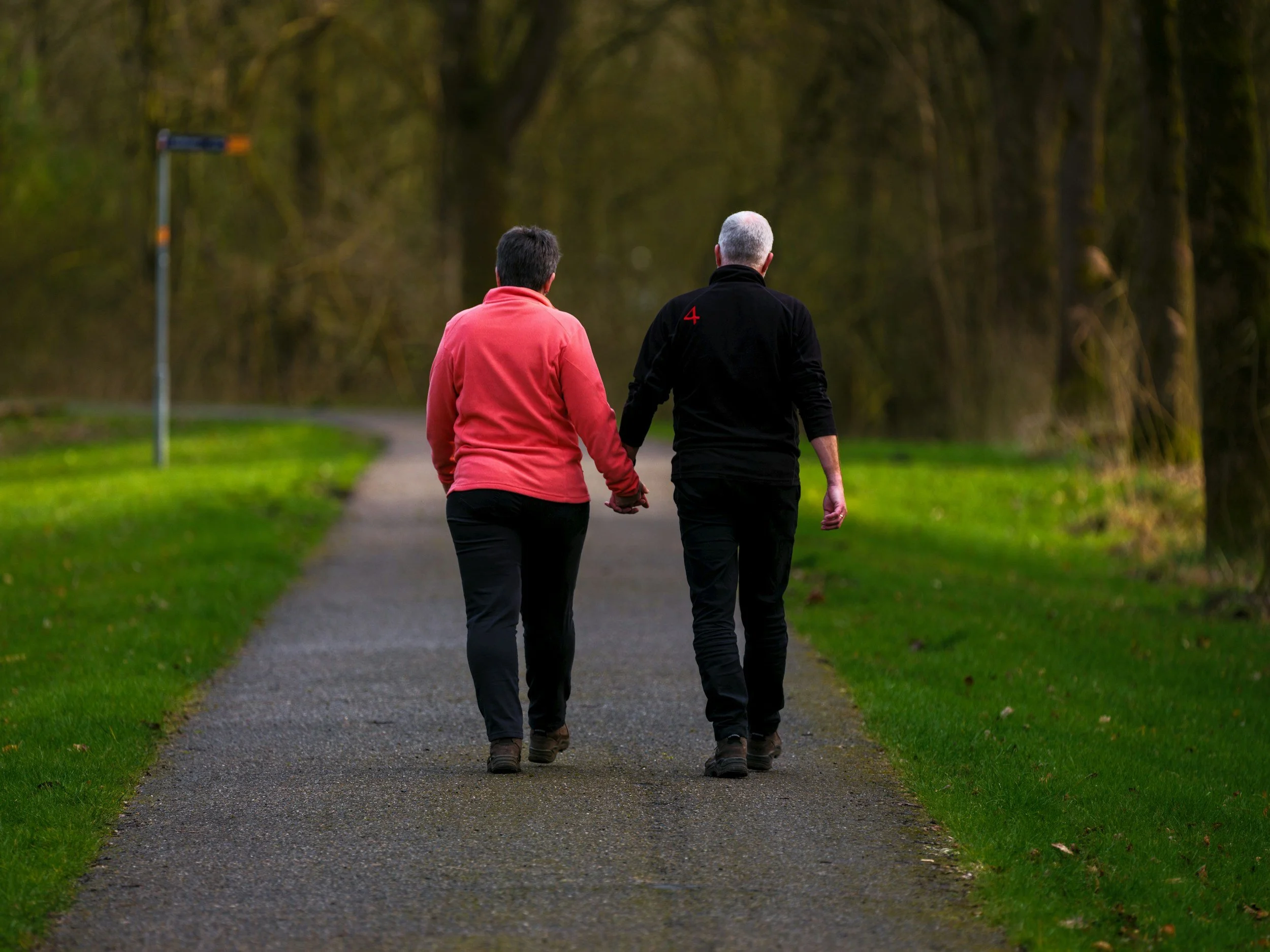 Two people walking in park