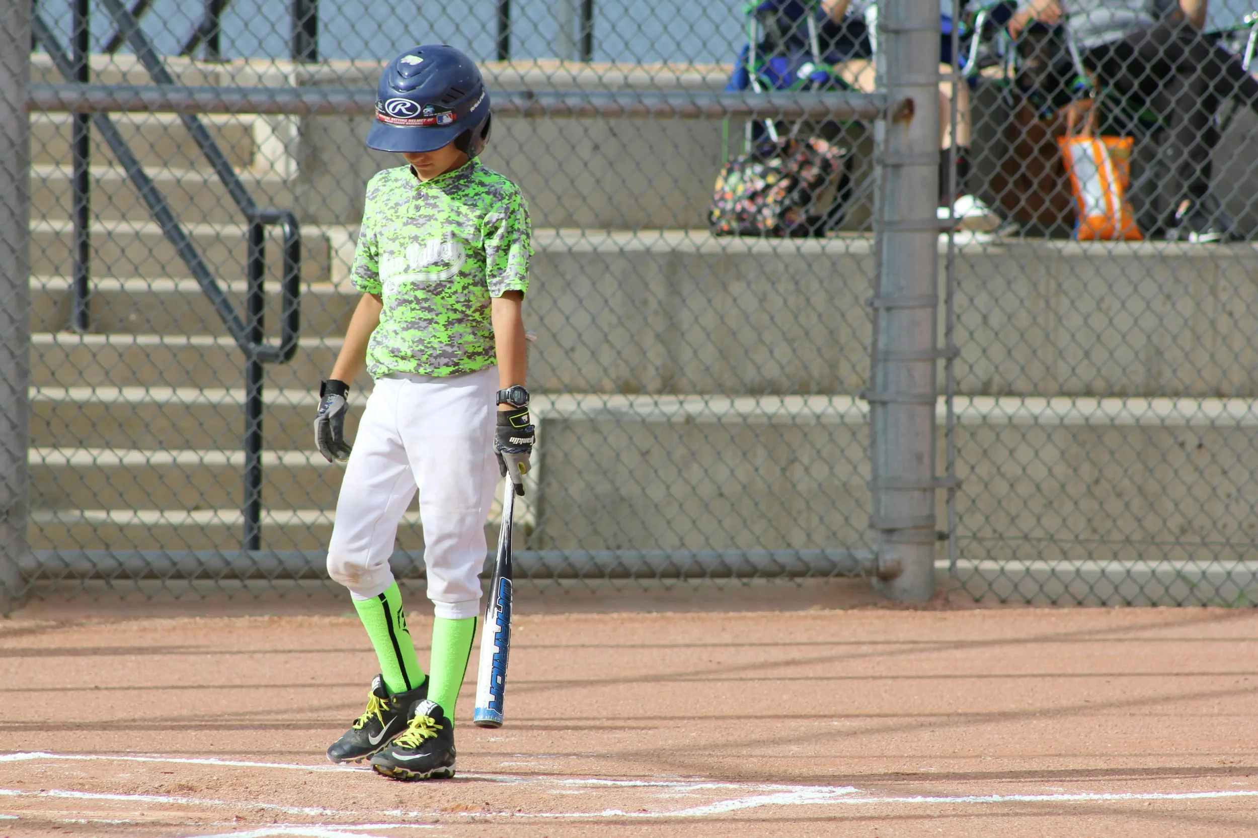 Little leaguer coming up to bat at a game.