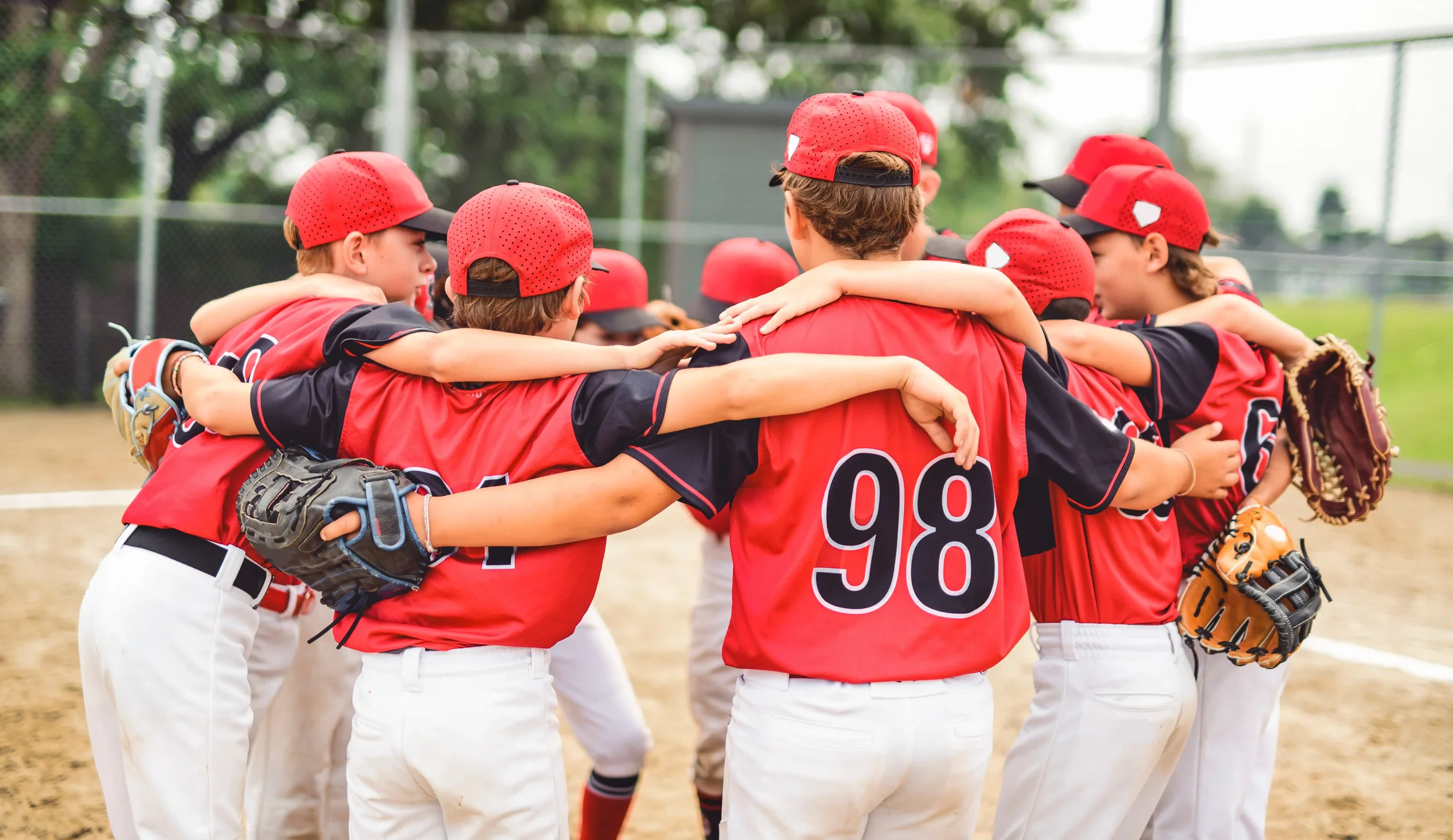 Baseball players in matching sublimated uniforms.