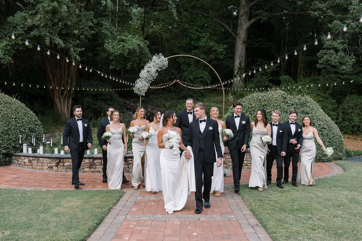 Surrounded by love, laughter, and the lush beauty of nature, this just-married moment on the brick pathway to the waterfall says it all. Little Gardens brings timeless romance to life—an outdoor wedding venue where every step is unforgettable.
