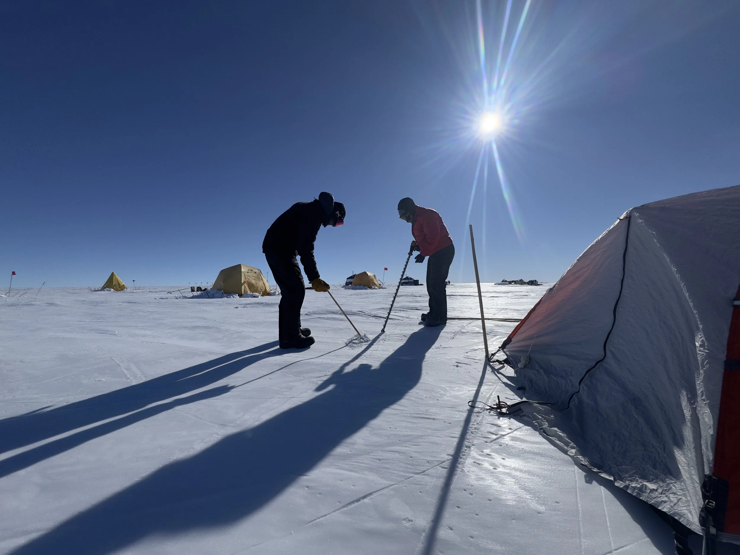   Securing our tents to the ground means drilling into the ice to attach bamboo stakes.  