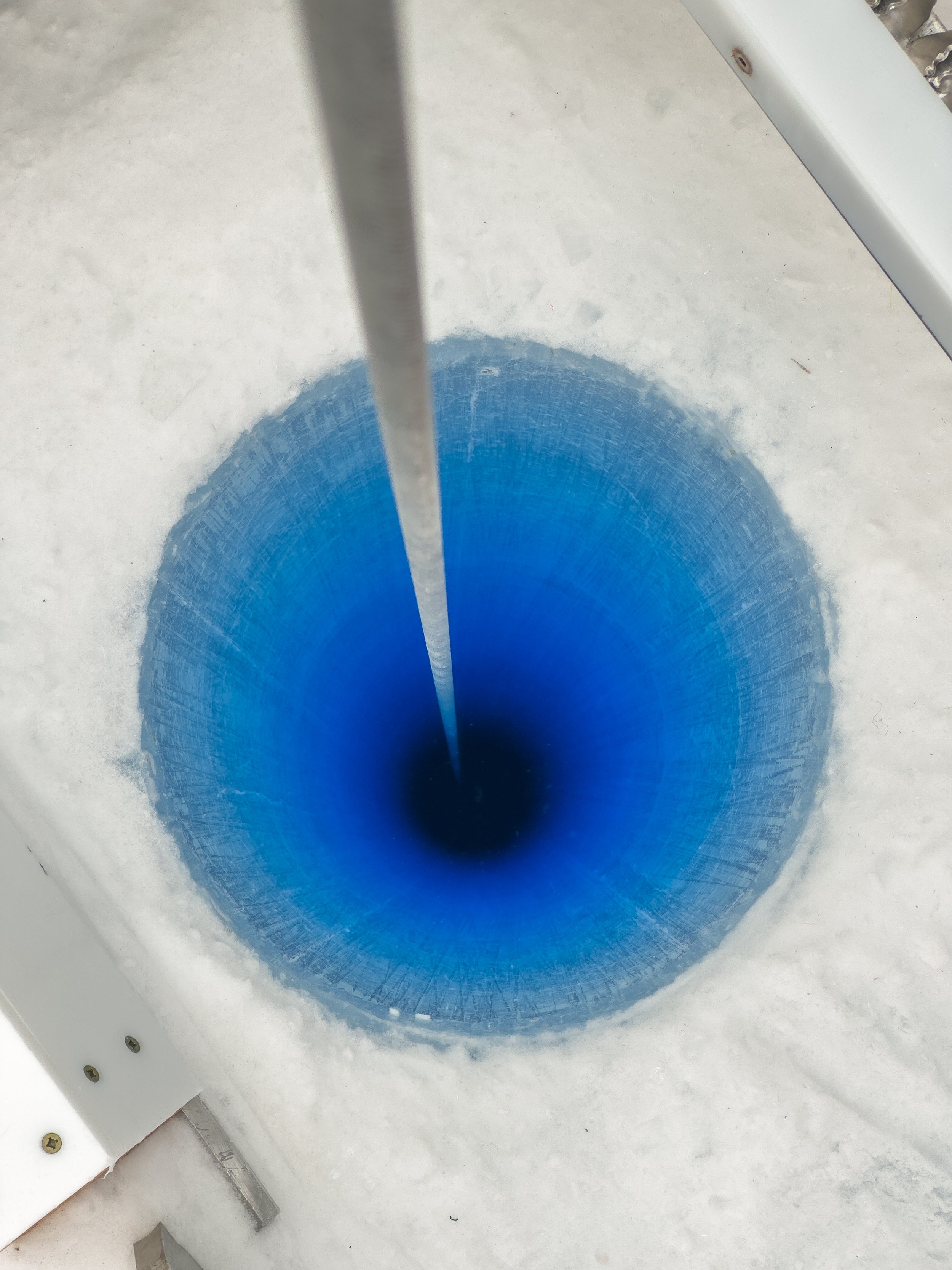 Peering into the Blue Ice Drill drill hole at the Allan Hills in 2026. Photo by Martin Froger Silva.