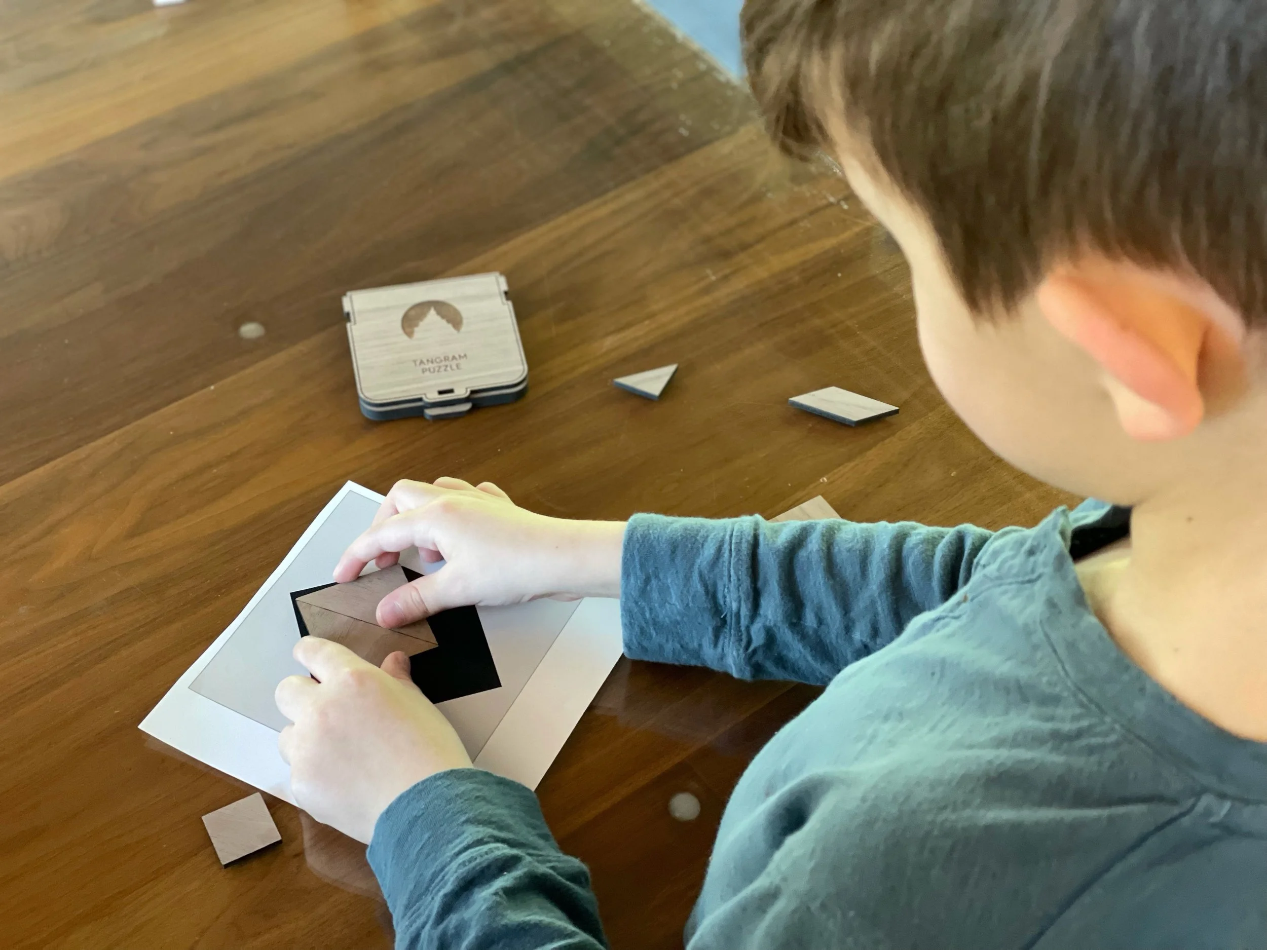 Using his custom tangrams