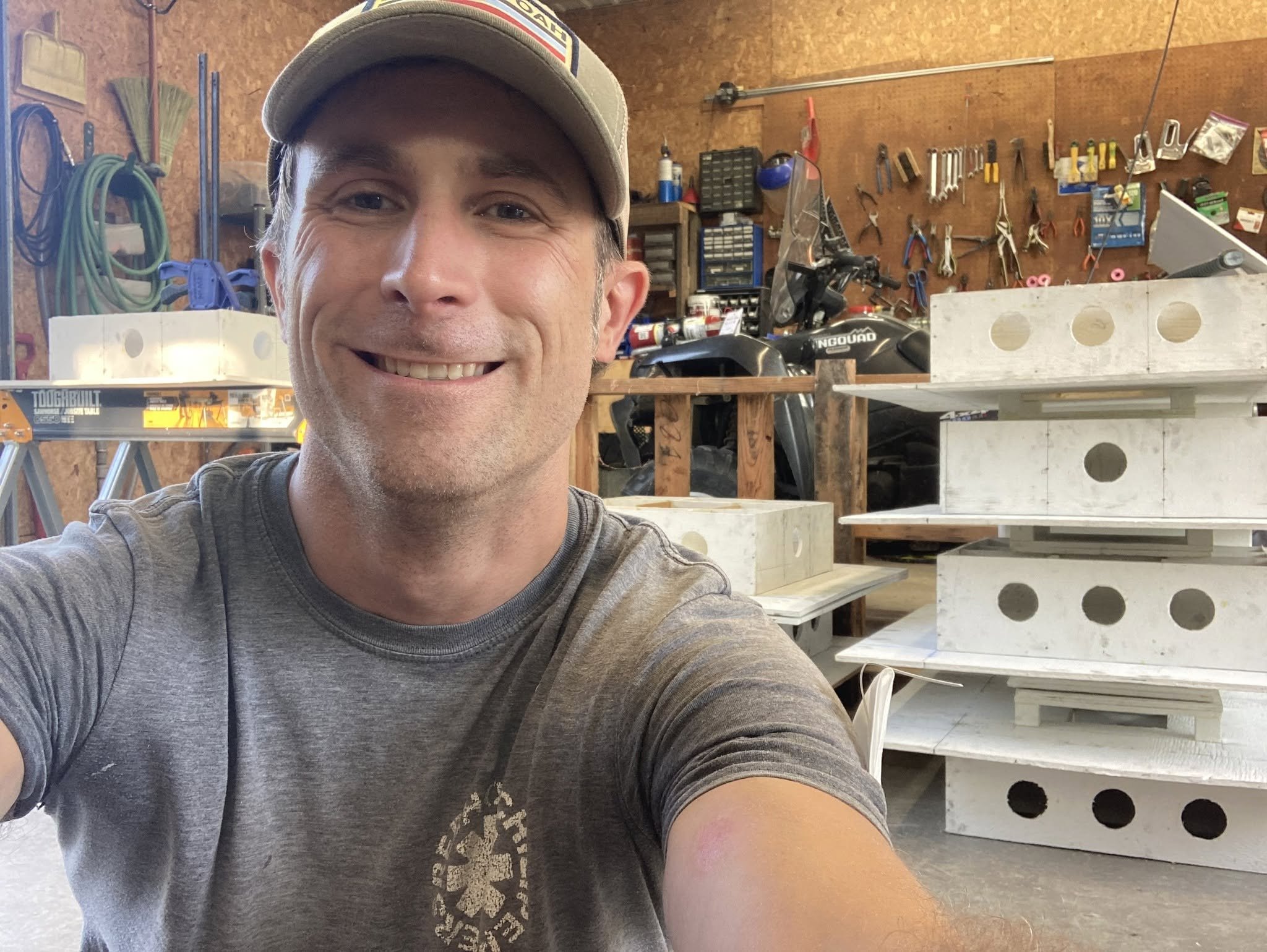 Photo of author with purple martin birdhouses in the background