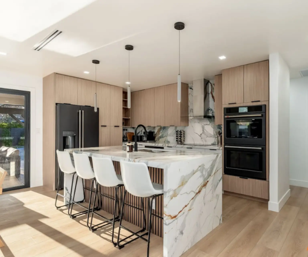 Elegant chef’s kitchen with high-end appliances, marble countertops, and spacious island designed for luxury vacation rentals.