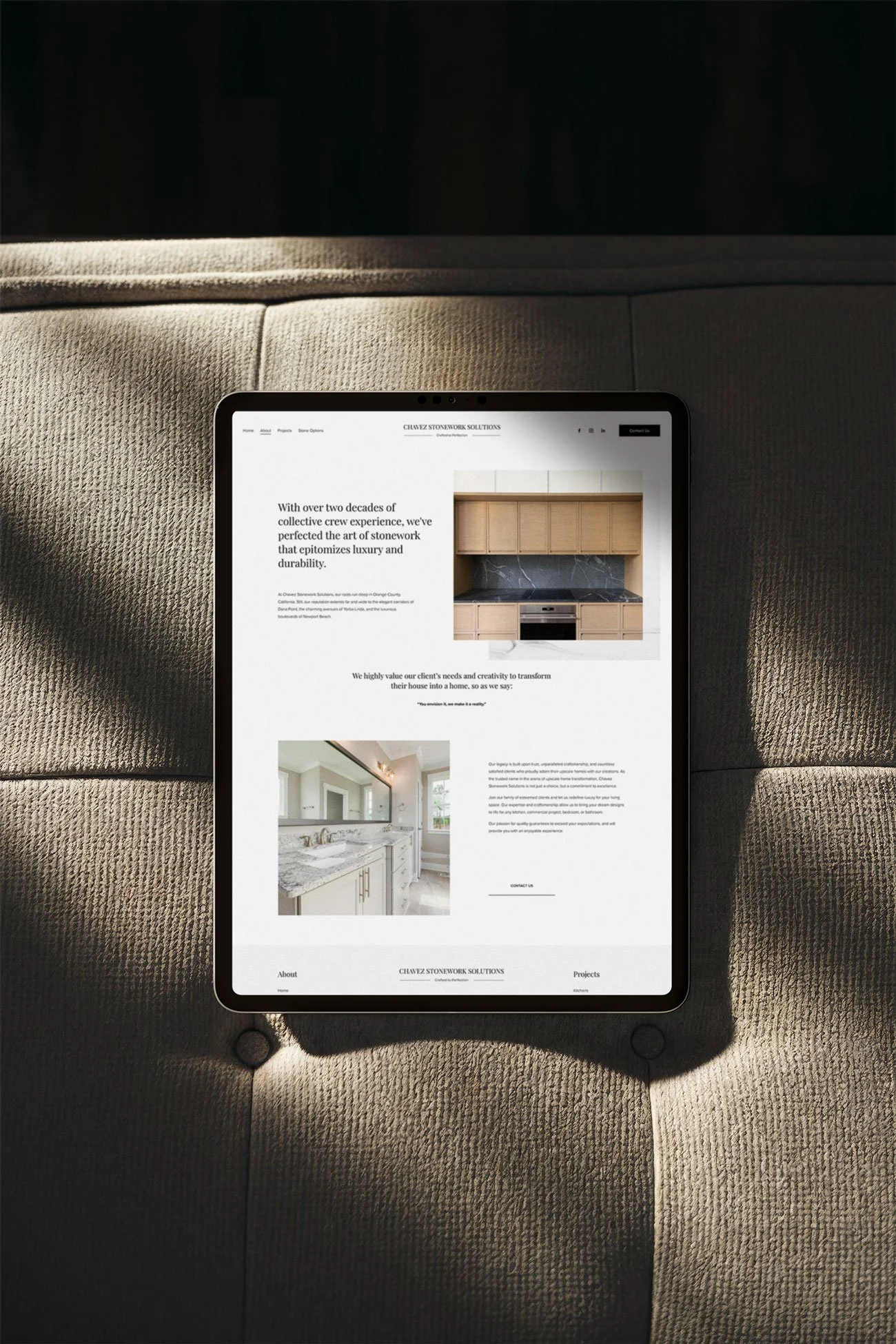 A tablet displaying a website on a sofa with sunlight shining on it.