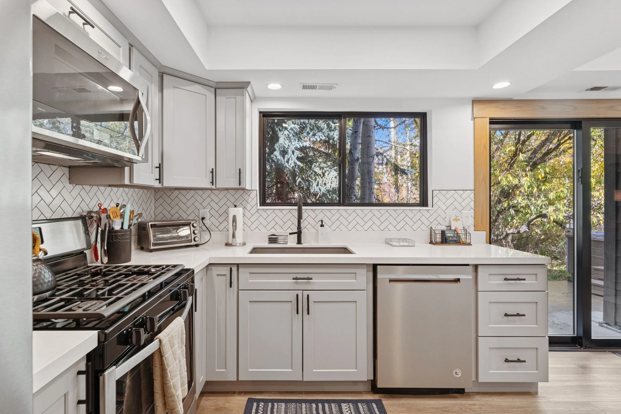 Fully stocked kitchen, oven, stove, refrigerator, freezer, ice maker, coffee machine, blender, serving dishes, and more.