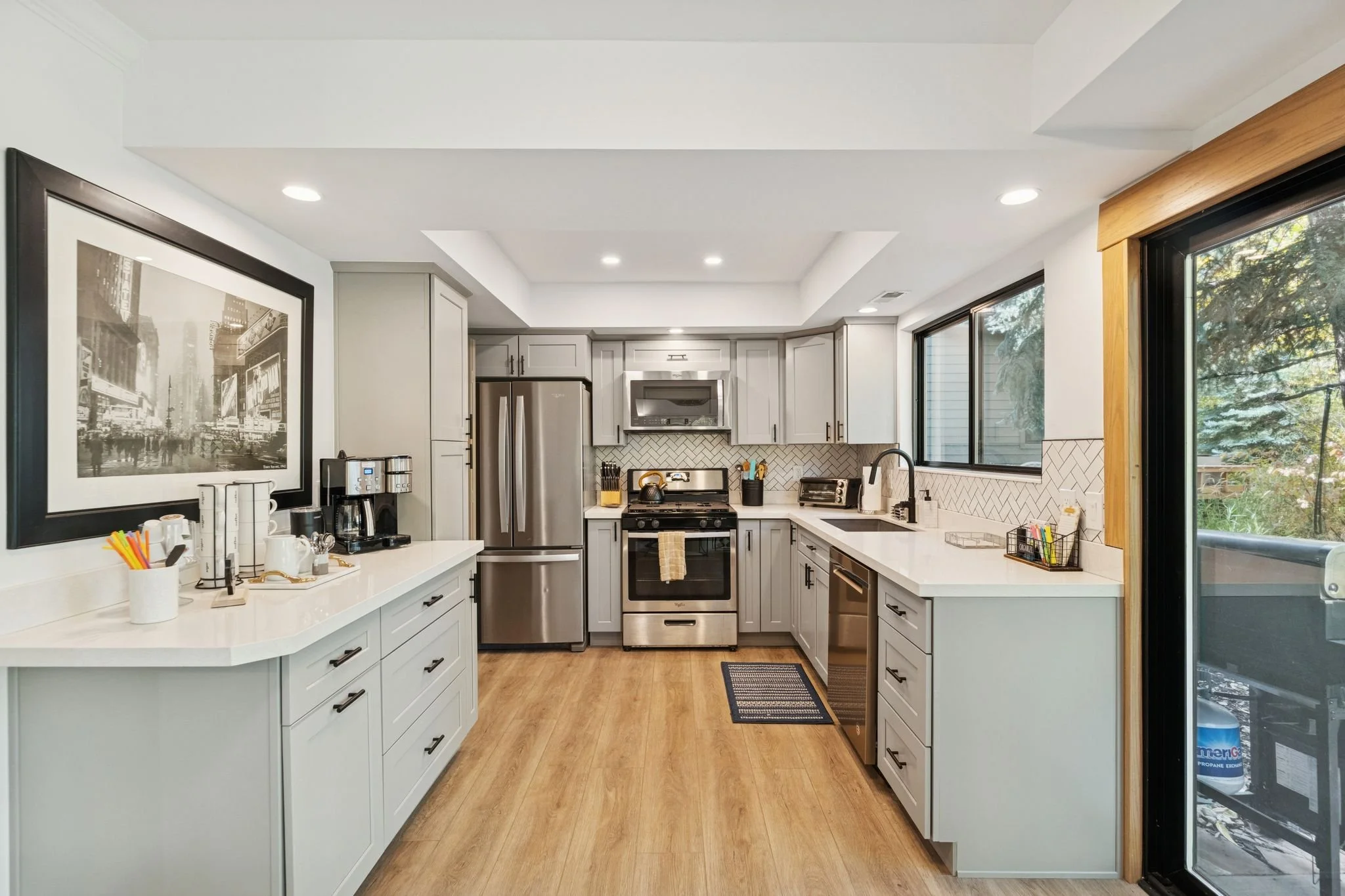 Fully stocked kitchen, oven, stove, refrigerator, freezer, ice maker, coffee machine, blender, serving dishes, and more.