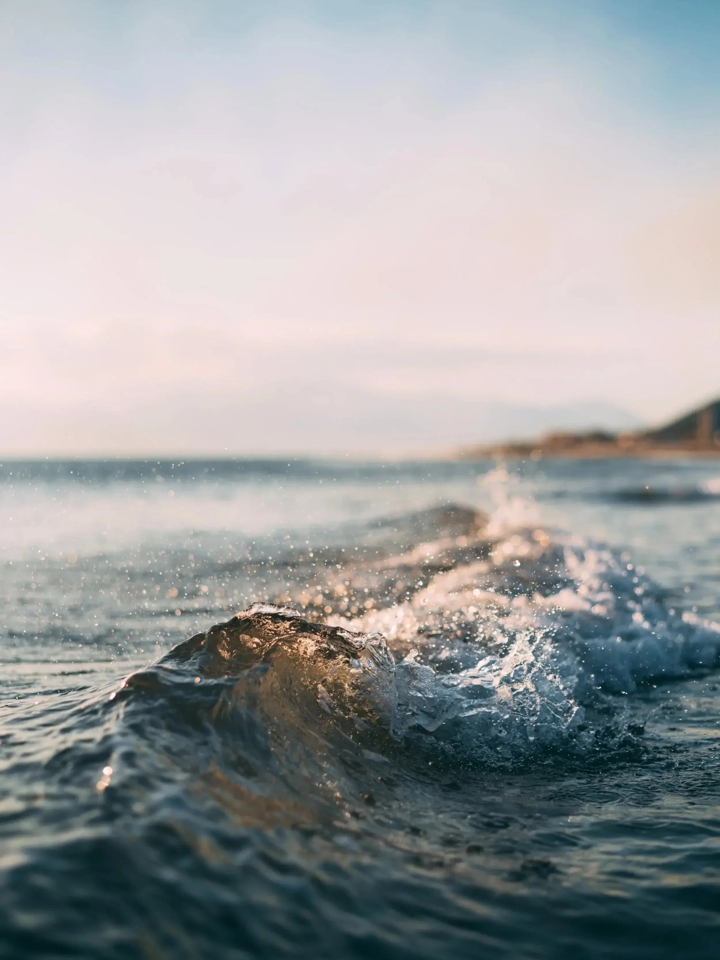 small wave splashing with sunshine shining through