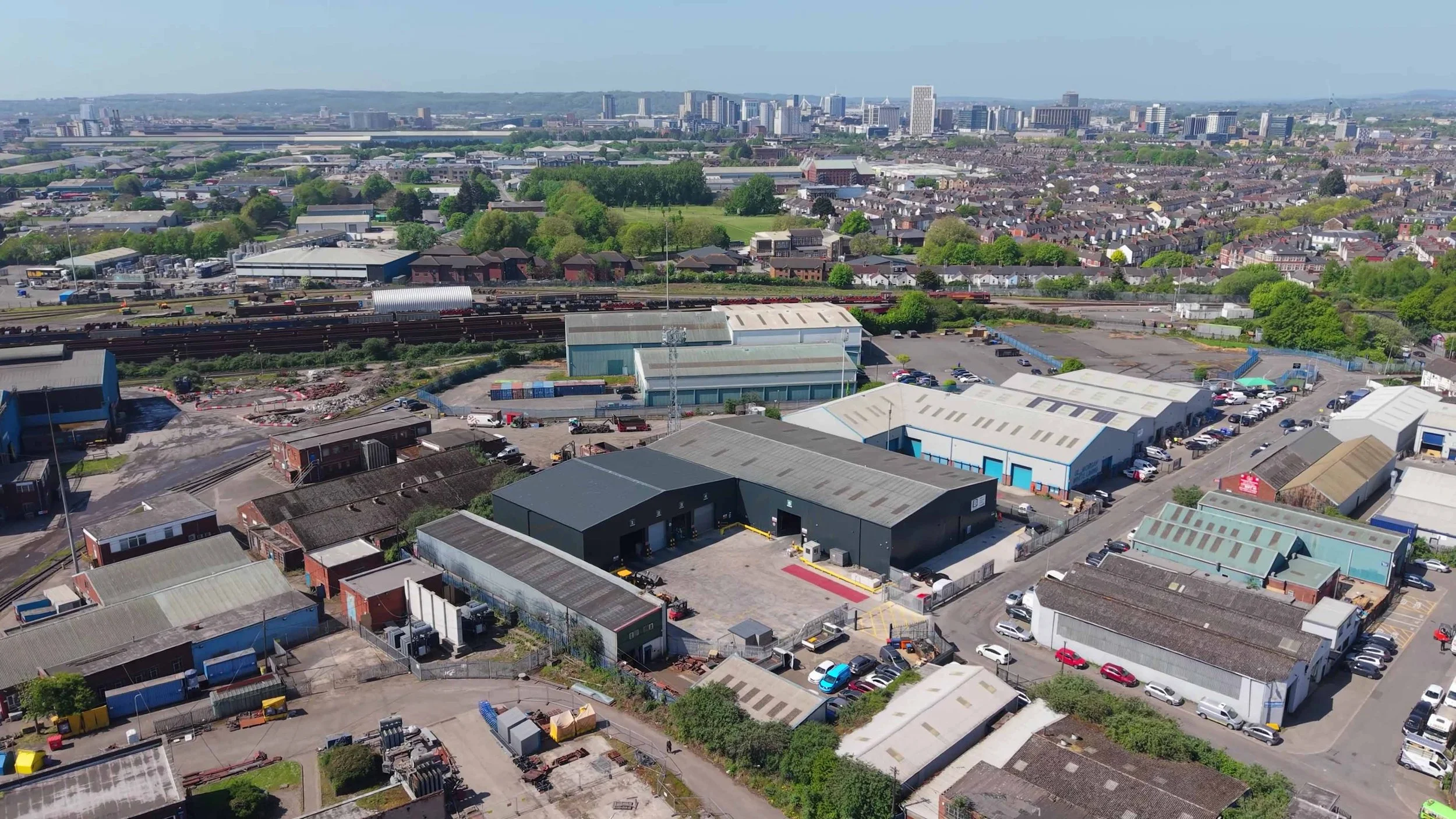 FPV drone view inside Plan B Recycling Centre, showing active recycling machinery, conveyor systems and large-scale industrial processing equipment in operation.