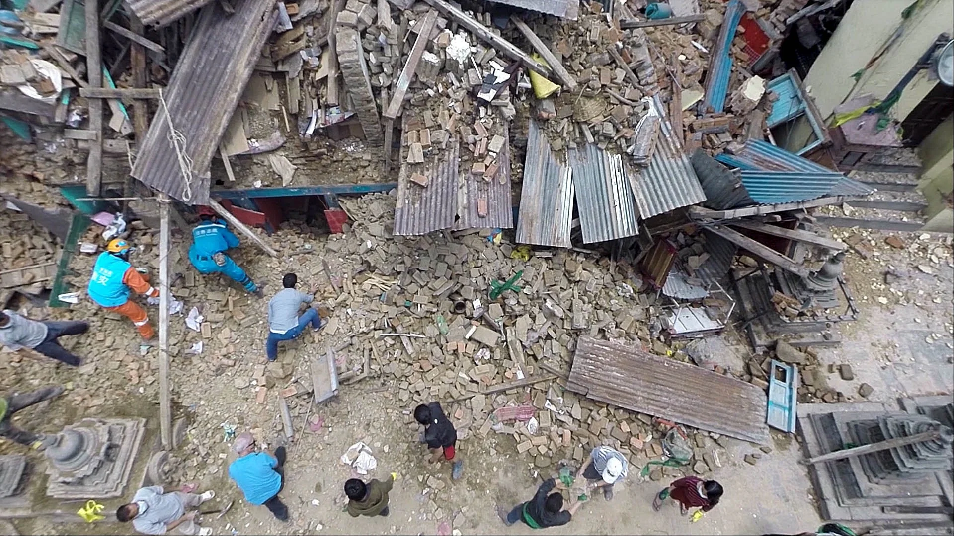 Aerial drone view of earthquake damage in Nepal, showing collapsed buildings, debris and the surrounding urban landscape after the 2015 Nepal earthquake.
