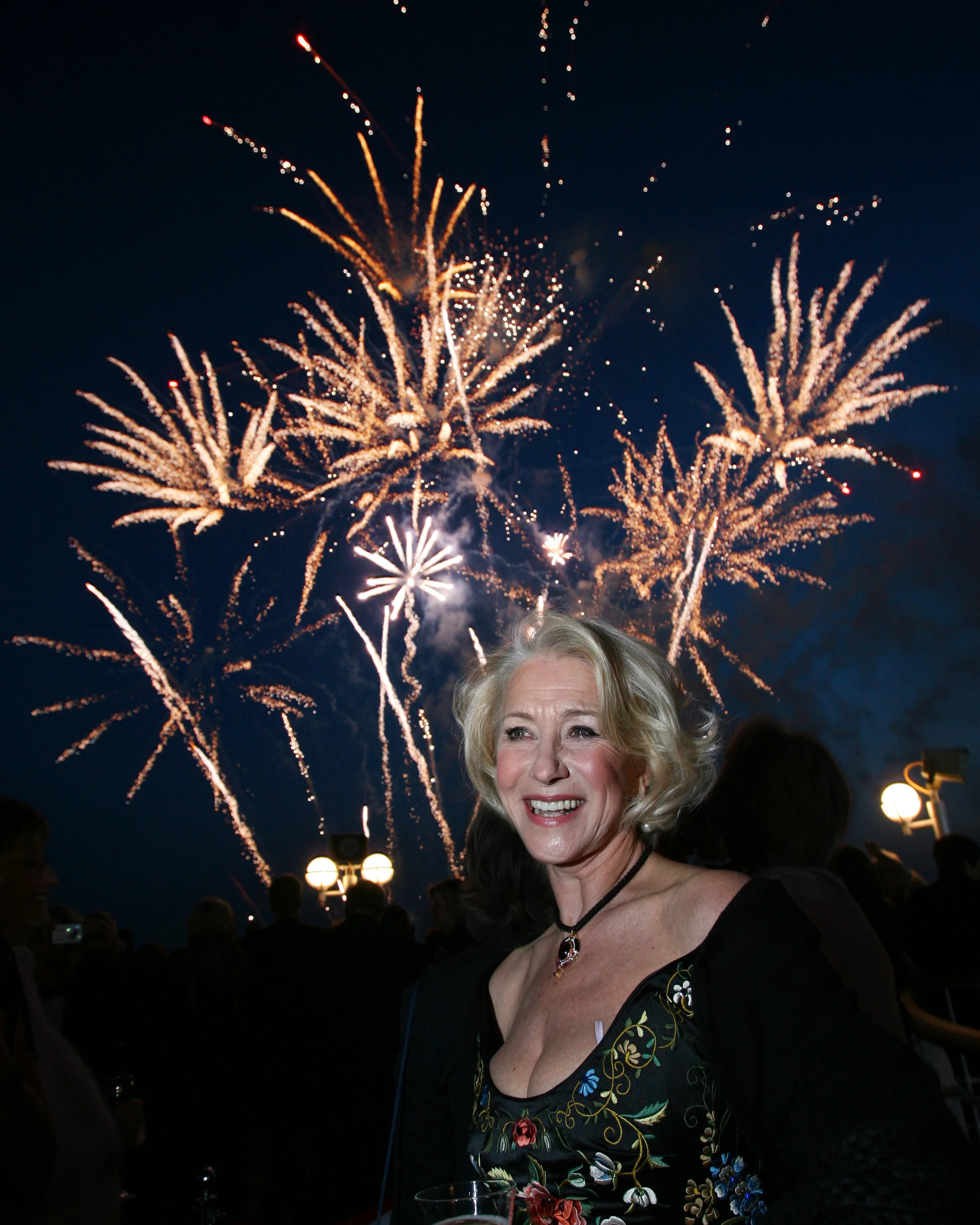 Iconic image by photographer Lewis Whyld of Dame Helen Mirren as she watches the fireworks aboard the P&O Cruises' vessel Ventura, during the official naming ceremony at Southampton Dock, Southampton