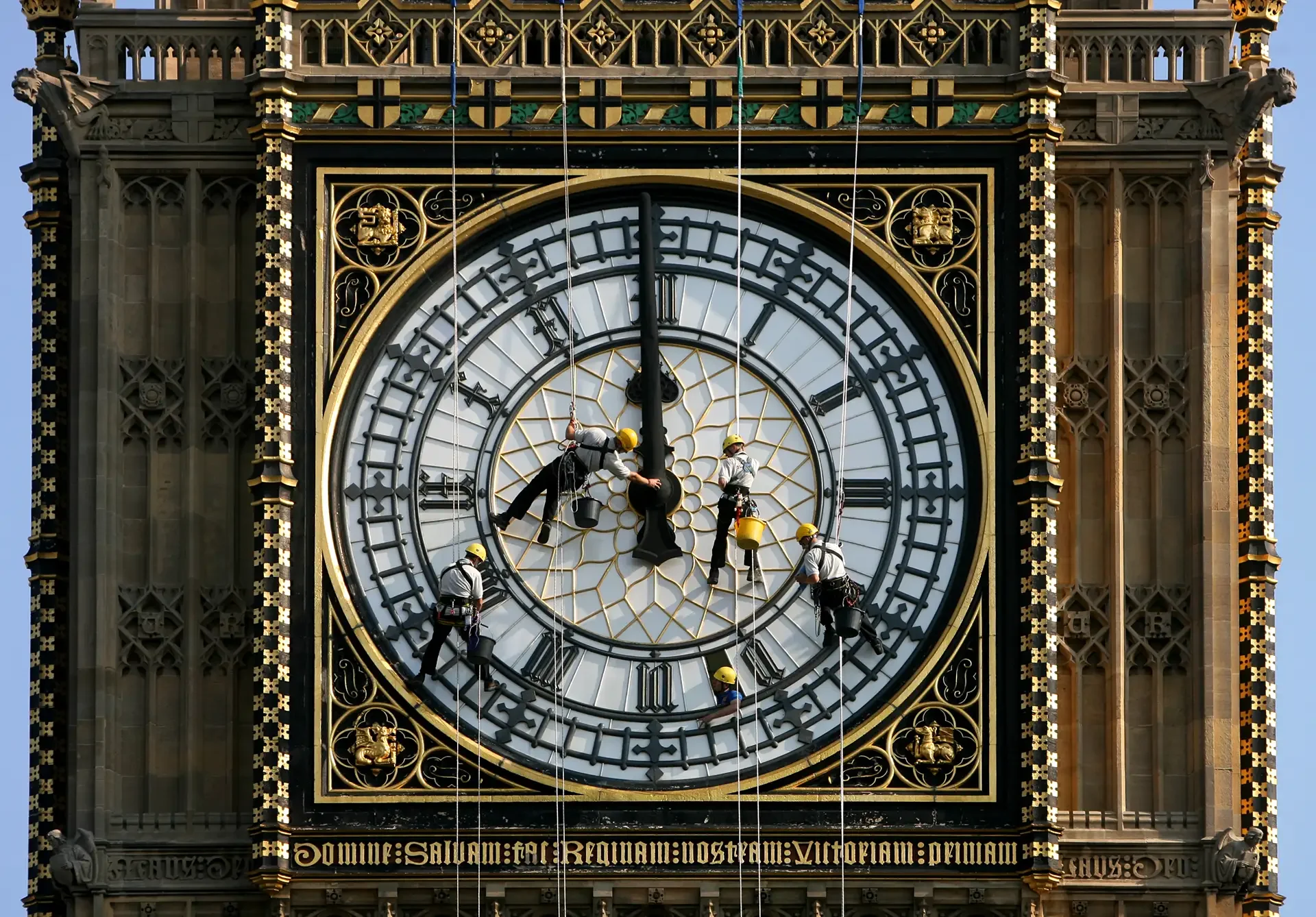 Photograph by Lewis Whyld of Engineers working on the clock face of Big Ben during restoration in London.