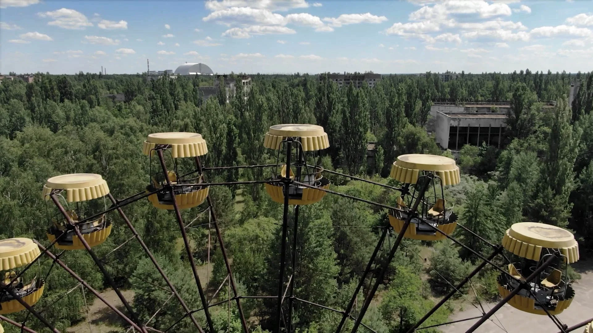 Aerial drone view of Chernobyl Reactor 4 and the New Safe Confinement structure, showing the vast nuclear site and surrounding restricted landscape in Ukraine.